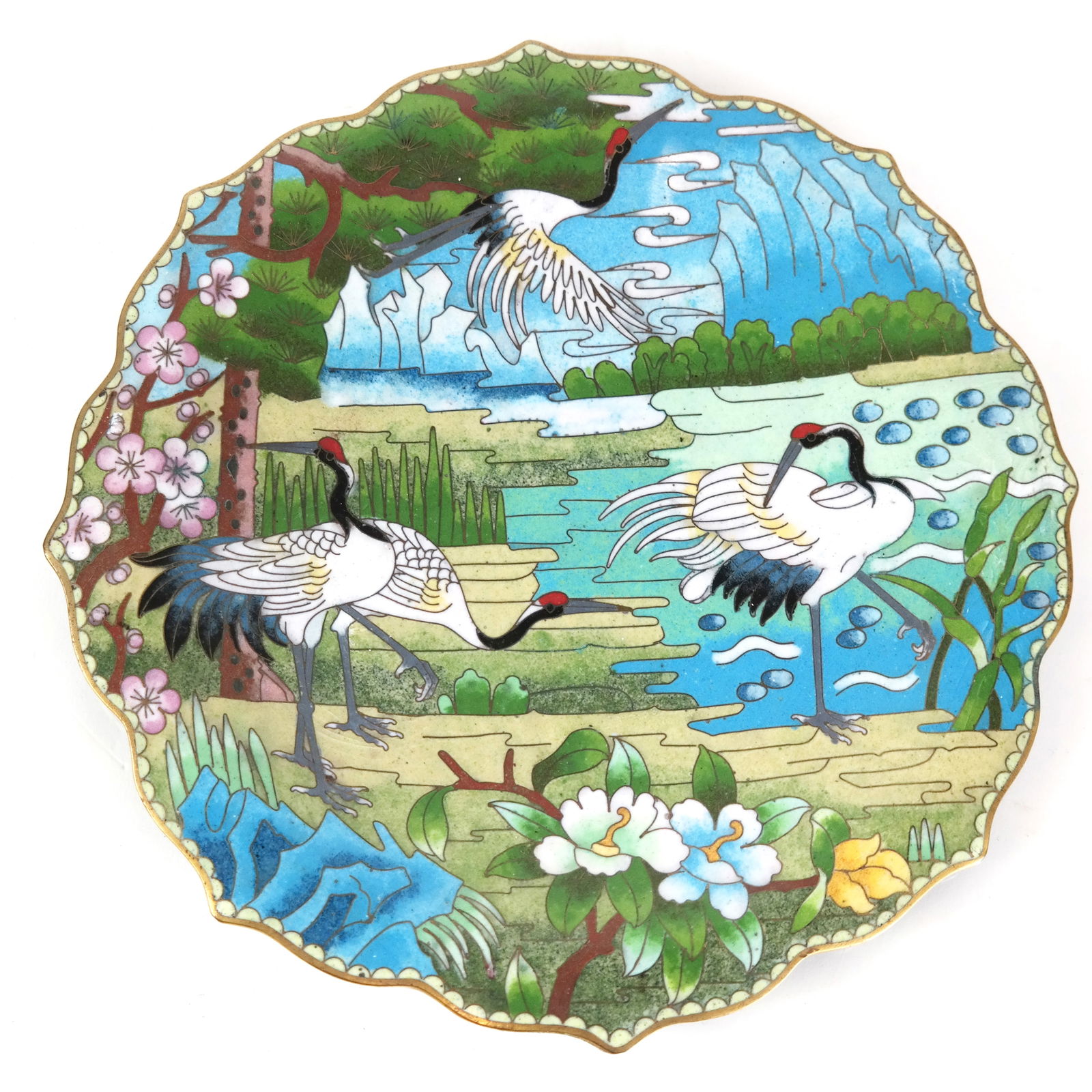 Chinese Polychrome Enamel Plate: Chinese polychrome enamel plate decorated with cranes in a lush landscape; label to base. [9 1/4" Diam.]. Area of loss to base, light wear to decoration.