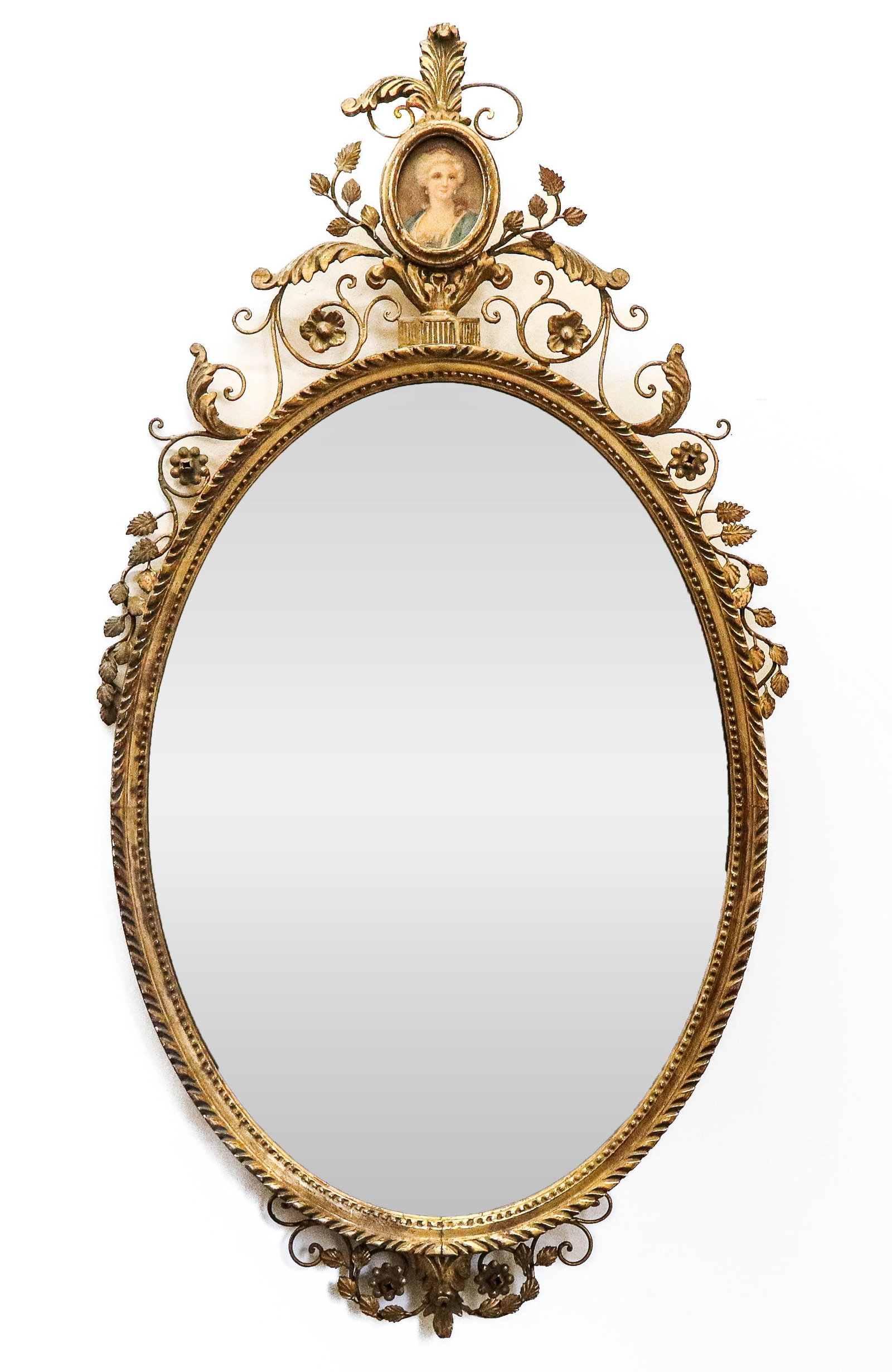 Adams Gilt Framed Oval Mirror: Adams gilt framed oval mirror, the top pediment (broken off) with an inset portrait picture of a woman, and gilt metal scrolls around top and bottom, gilt beaded frame. 20th century. [40" x 22"]. Brok