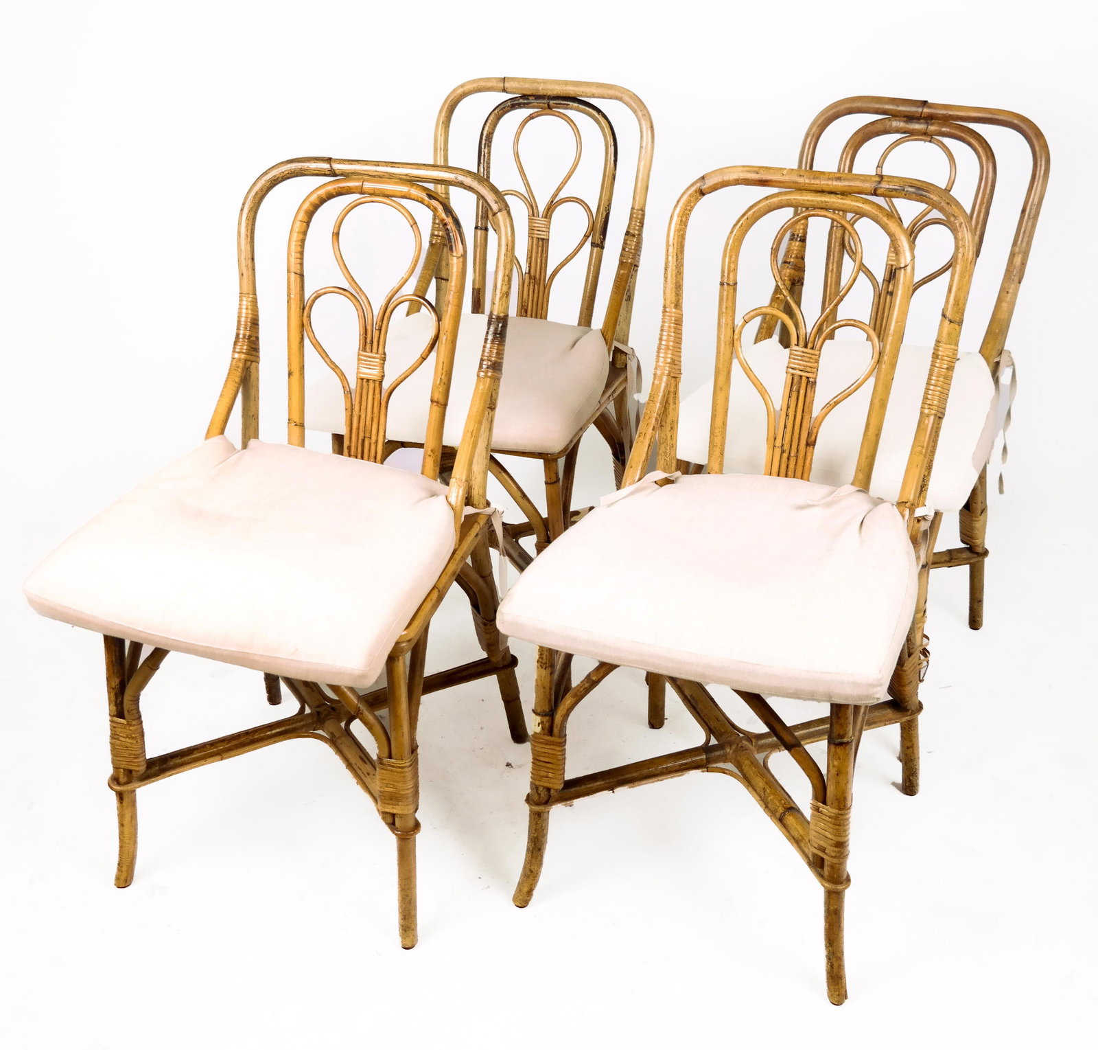 Rattan Dining Chairs, 4: Early 20th century openwork design dining chairs with caned seats. From a New York City collection. In overall good condition; four caned seats in good condition.