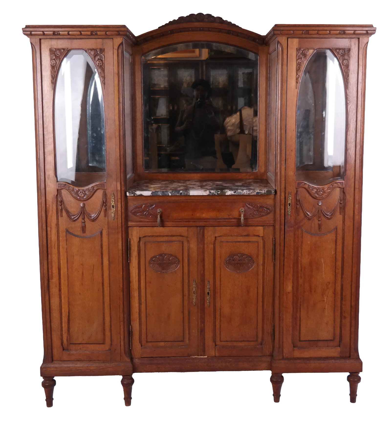 Art Nouveau Display Cabinet: Early 20th century oak three-section display cabinet with beveled glass and garland relief work. [72" H x 64" W x 19" D]. From a New York City collection. In good condition.