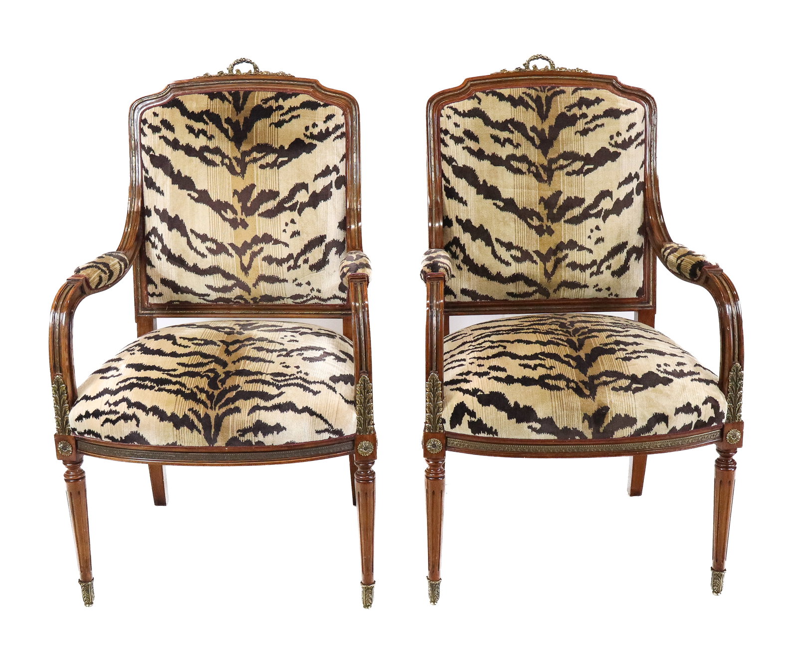 Pair Louis XVI Open Arm Chairs: Pair Louis XVI style open arm chairs with faux tiger upholstery and pad arms, gilt bronze mounts and trim, and wreath handle backs, fluted legs ending in bronze caps. [44" H x 25" x 27" D]. Very good