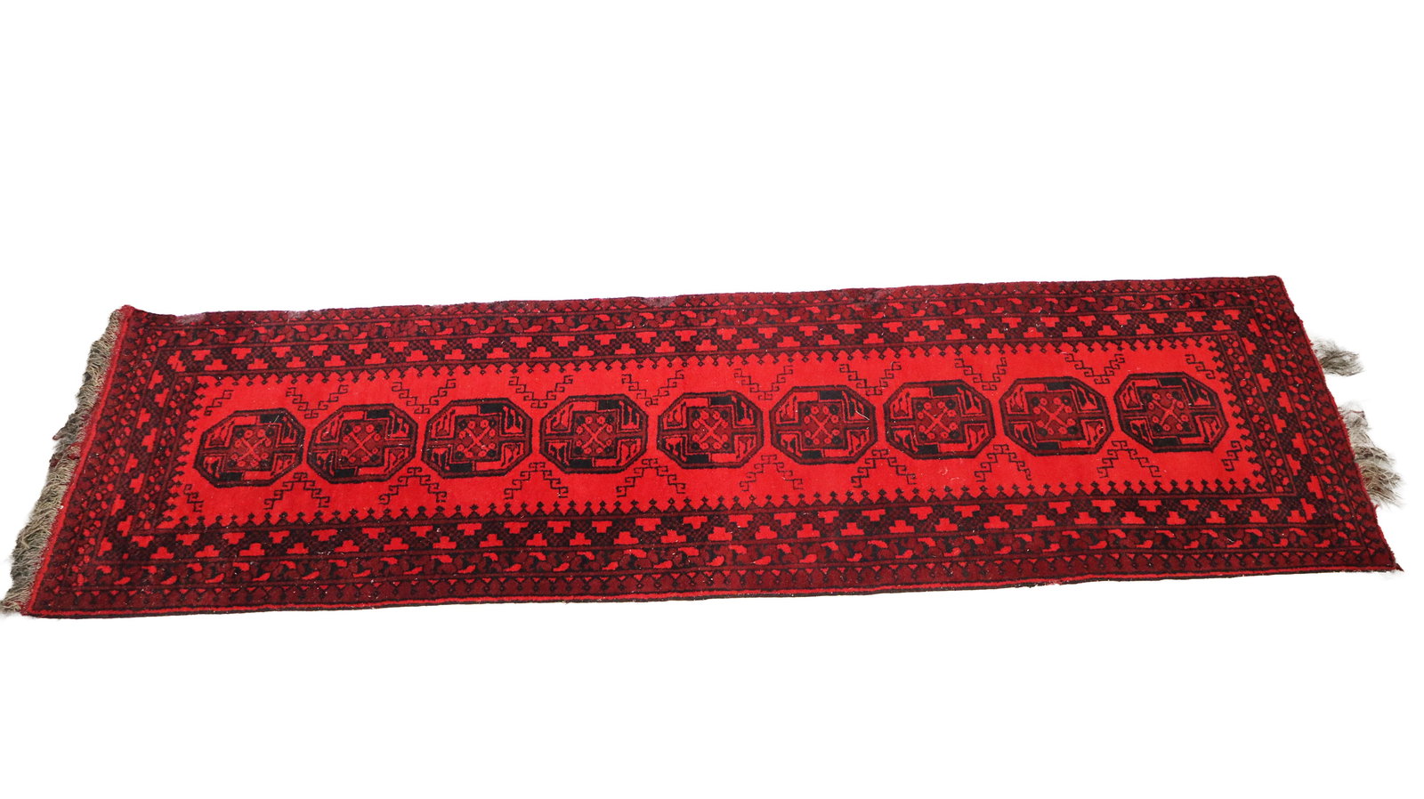 Handmade Wool Aqcha Runner: Handmade wool Aqcha runner, Afghanistan, early 20th century, with interlaced geometric design and hand-knotted construction, and tassels to edge; marked Aqcha and wool to label with handmade. [115" L