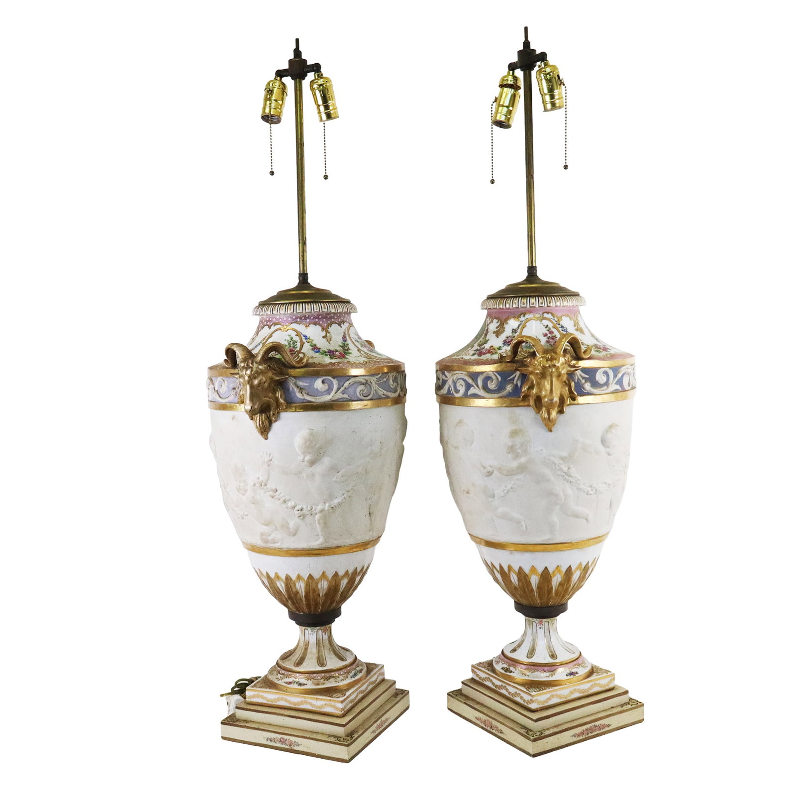 Pair Large Porcelain Vase Lamps: Pair large porcelain vase lamps, each with soft paste porcelain center rings of dancing cherubs and gilt rams head handles, upper on one of clean porcelain and the other with a rough finish, the lower