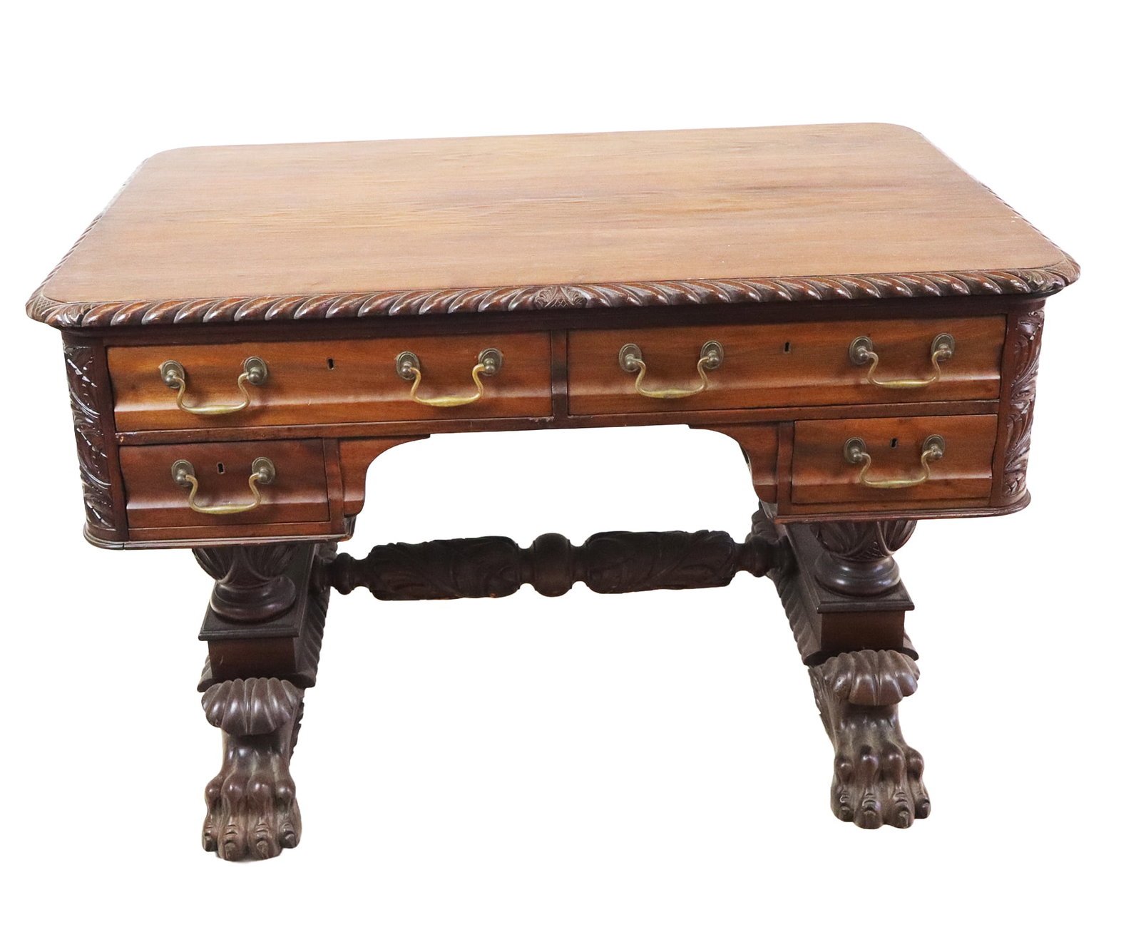 Duncan Phyfe Manner Desk: Duncan Phyfe manner desk, a gadroon rimmed top over rounded corner desk with 5 drawers, atop a center trestle and large winged paw footed base. [28" H x 46" W x 31" D]. Overall good condition, no visi