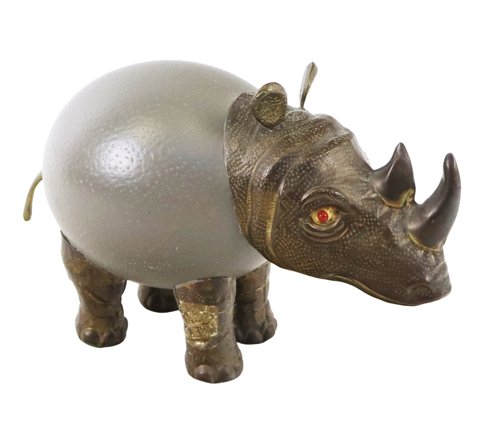 Ostrich Egg and Brass Sculpture of a Rhinoceros: Ostrich egg and brass sculpture of a rhinoceros, 20th century, with red eye detail, unmarked. [7" H x 11.5" W x 5" D]. Condition is good with patina.