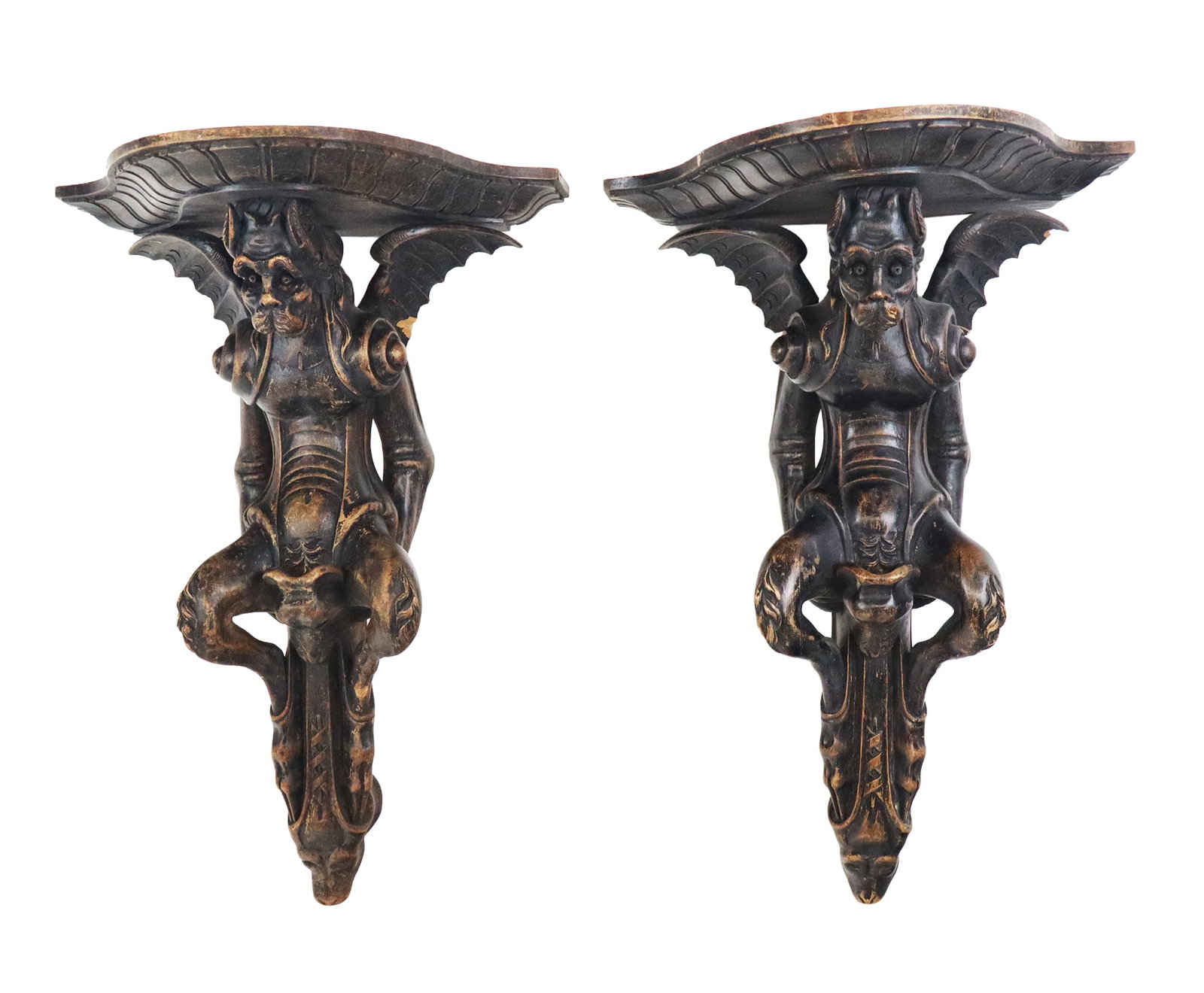 Pair of Gothic Revival Carved Gargoyle Brackets: Pair of Gothic Revival carved and painted wood gargoyle brackets. [16.5" H x 11.5" W x 8" D]. Overall condition is fair, some losses, wings broken with parts deficient on back. From the esteemed colle