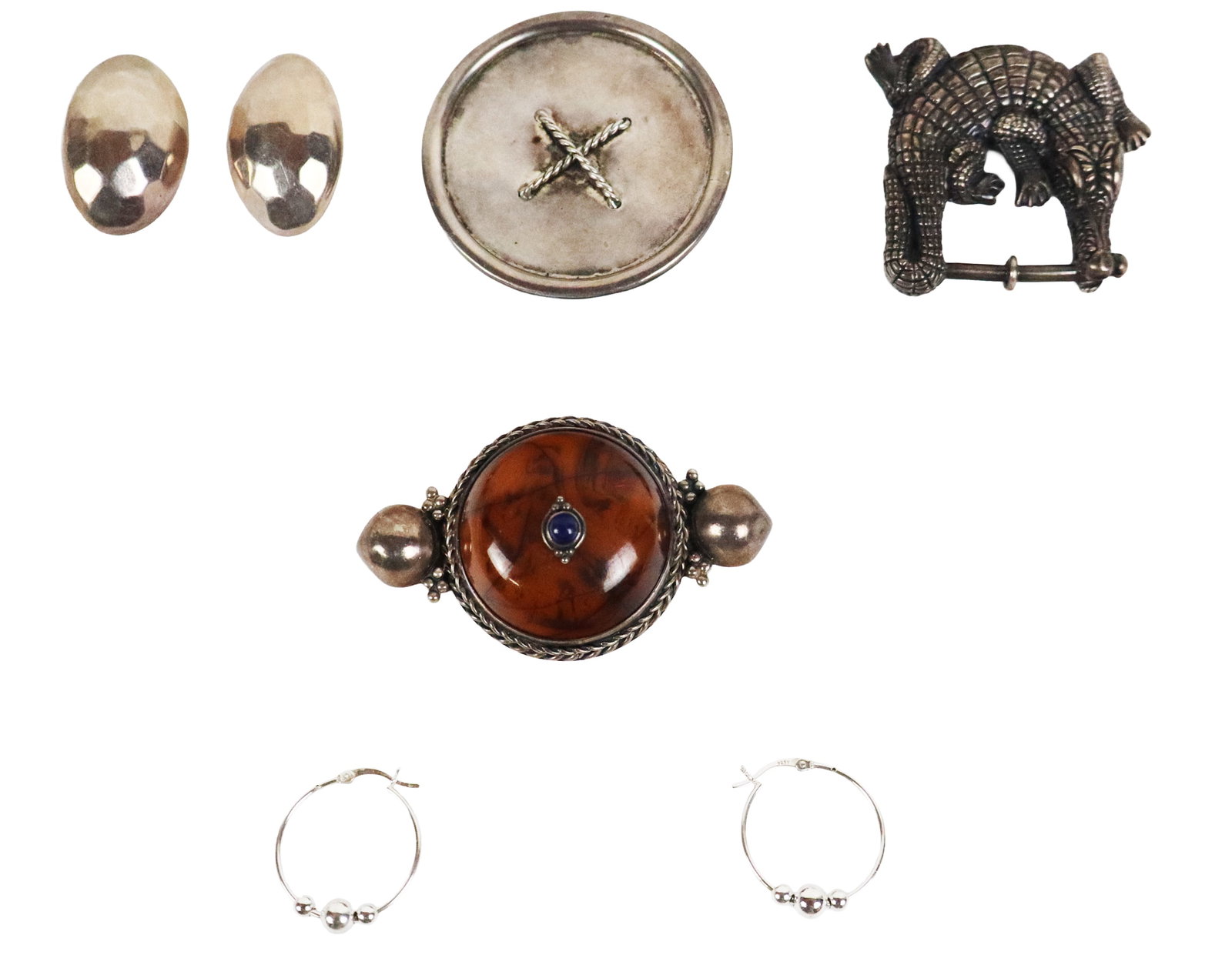 Group of Sterling Silver Jewelry, 7: Group of assorted sterling silver jewelry, comprising an alligator buckle in the style of Kieselstein-Cord, a pair of hammed dome shaped ear clips, a pair of sterling silver small hoops, a Tom & Jenny