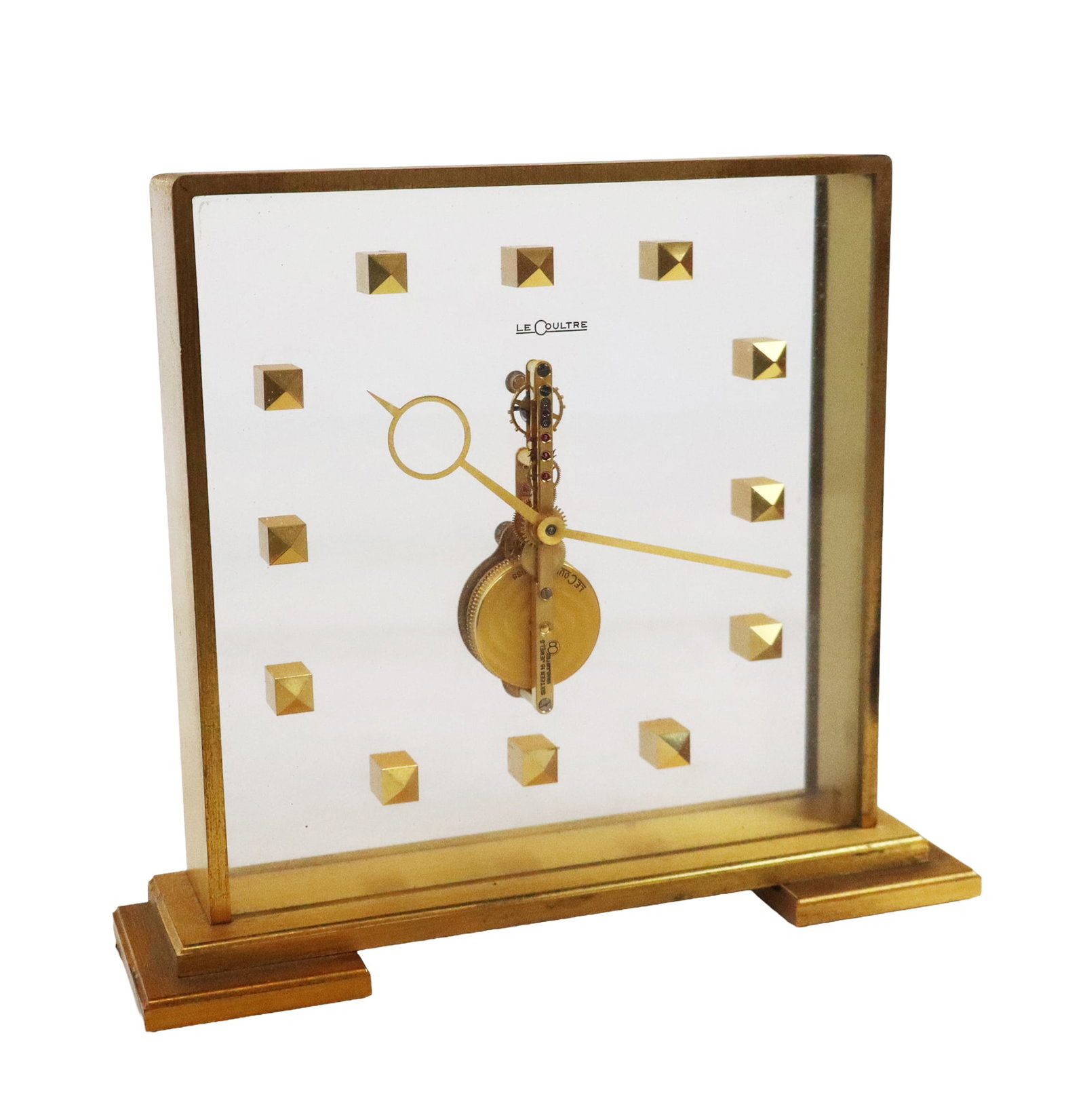 LeCoultre Mid-Century Modern Brass Skeleton Clock: Le Coultre mid-century modern brass and glass skeleton clock, marked on base "Le Cooultre 354", on movement "Le Coultre Co. Swiss 16 Jewels unadjusted". [6.5" H x 7.25" W X 2" D]. Overall condition is