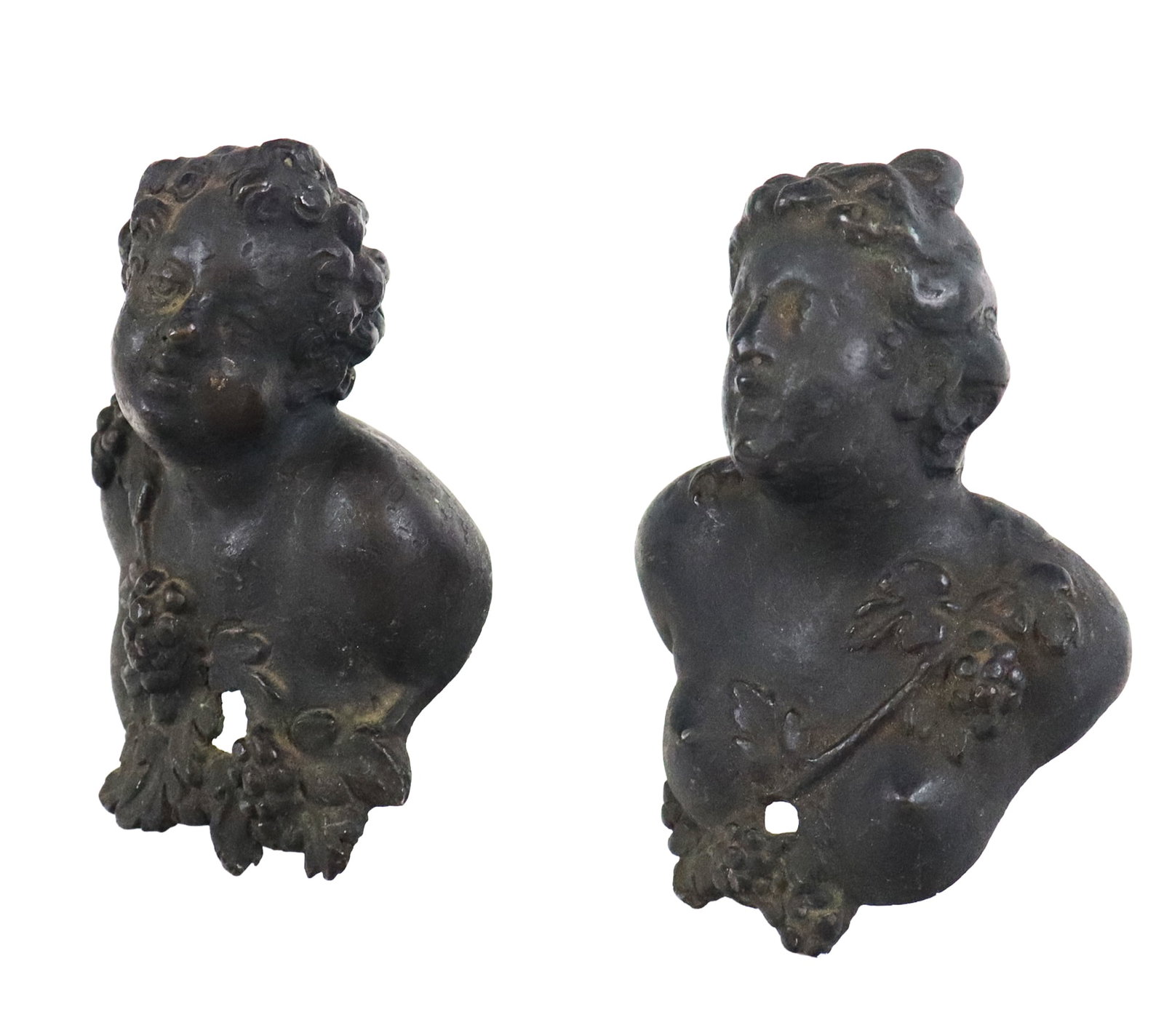 Pair of Victorian Figural Iron Appliques: Pair of Victorian figural cast iron appliques, 19th century, comprising a man and a woman with Bacchic decoration, likely meant for furniture. [5" H x 4" W x 4.5" D]. Condition is good with light rust