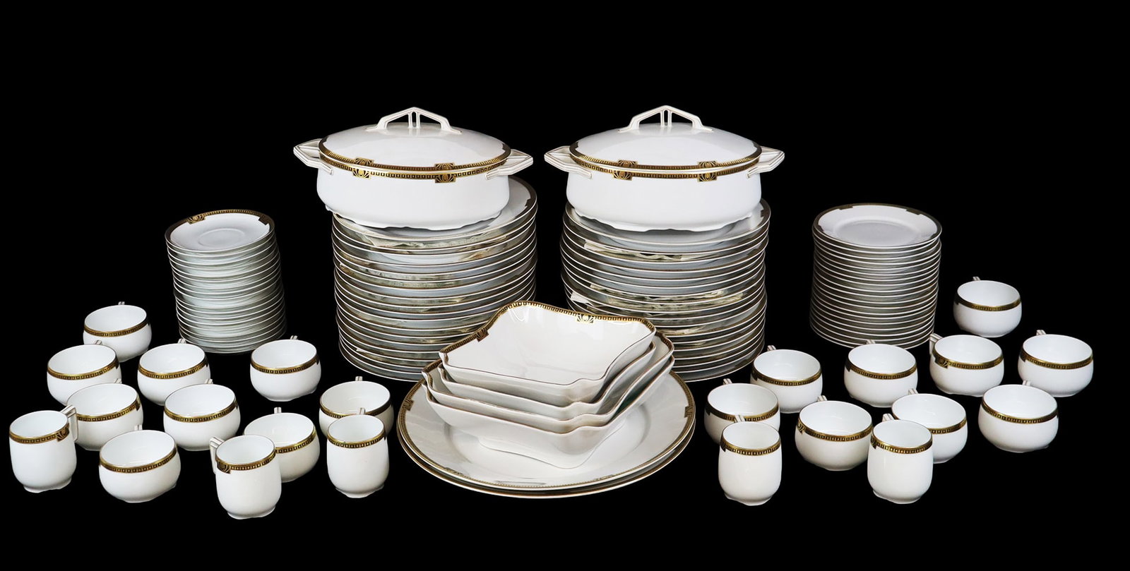 Krautheim & Adelberg Porcelain Service, 180+: Krautheim & Adelberg porcelain gilt and black decorated dinner service, comprising two circular serving platters with handles [12.25" x 10.75" W], five graduated oval platters [Largest: 19" L x 12" W]