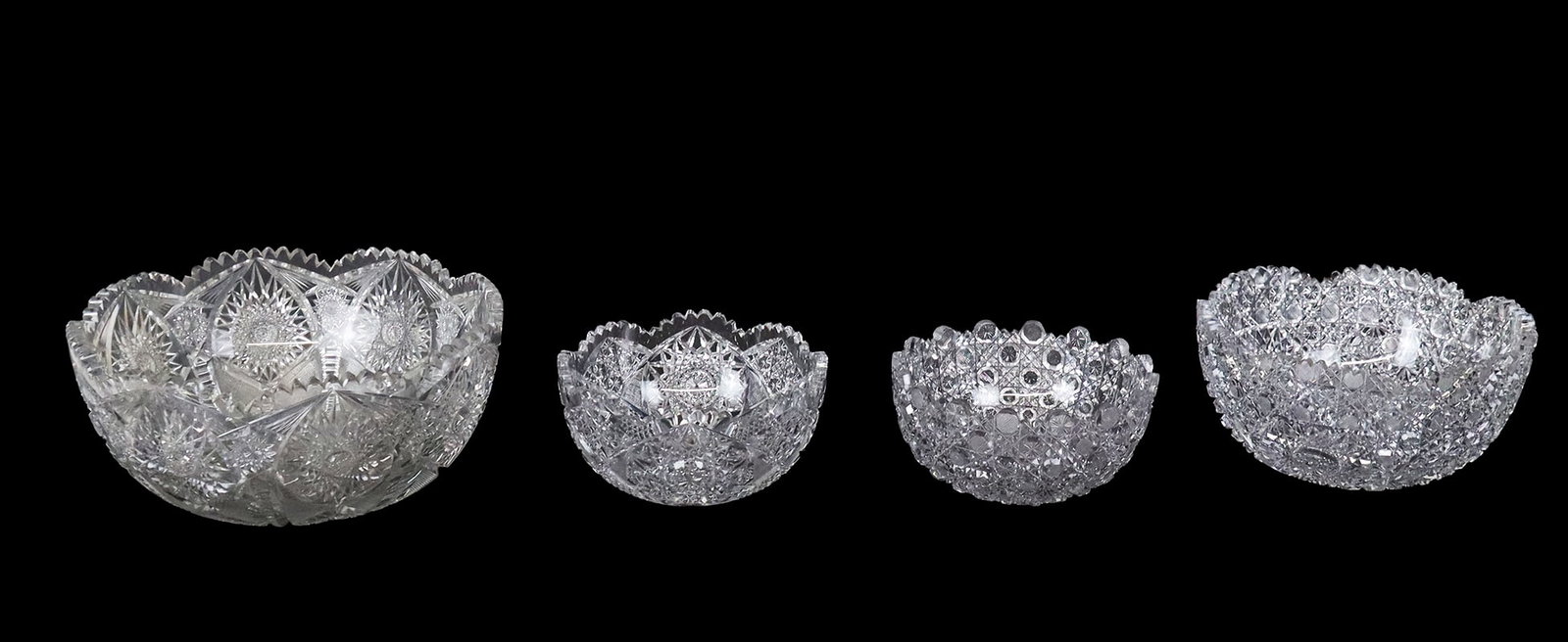 Four Cut Crystal Bowls: Four cut crystal bowls, 20th century, including a punch bowl, all apparently unmarked. [Punch bowl: 6" H x 12.25" Diameter]. Condition is good with age-commensurate wear.