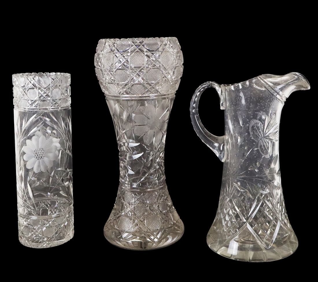 Three Articles of Cut and Etched Crystal: Three articles of cut and etched crystal, 20th century, comprising two vases and a pitcher, all with floral decoration, each apparently unmarked. [Tallest: 15" H x 7" Diameter]. Condition is good with