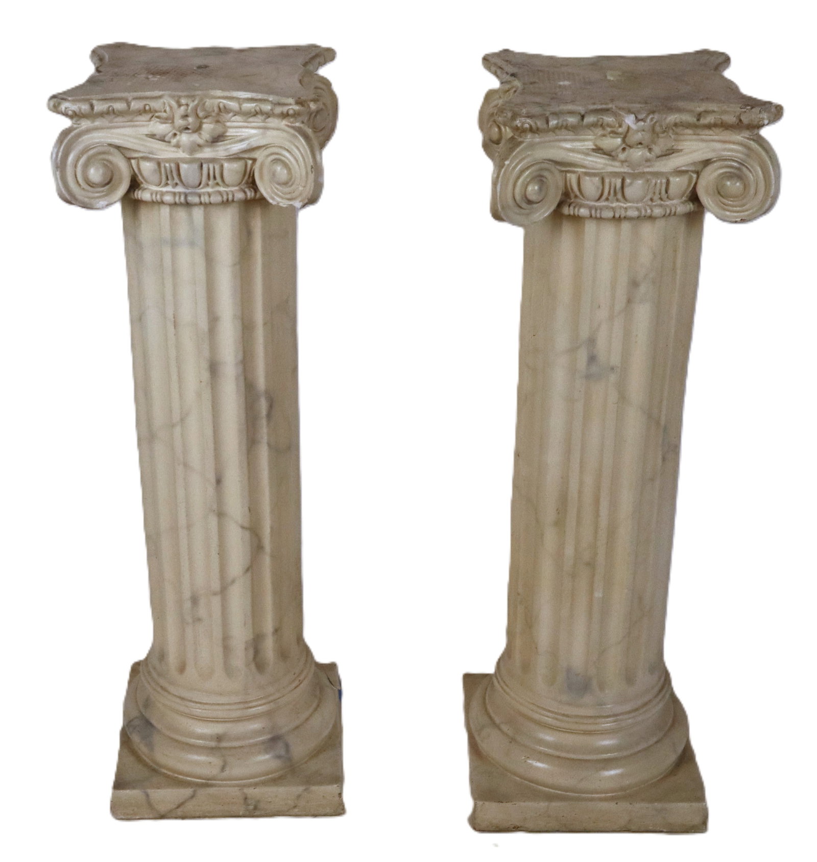 Pair of Faux Painted Marble Columns: Pair of faux painted marble columns, 19th century, in the ionic order, with plaster construction. [36.5" H x 12" Square]. Condition to each is good with some repairs, and wear to top of each.