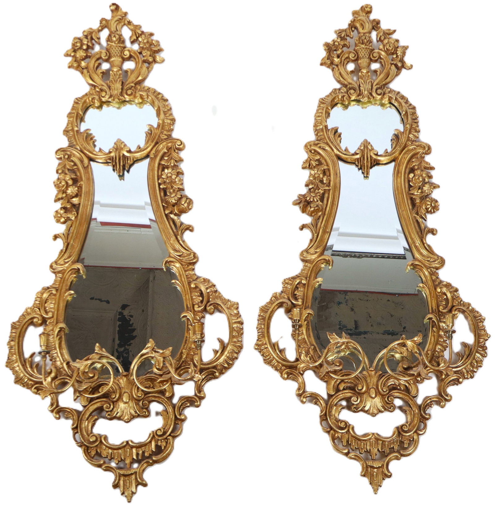 Pair of Italian Rococo Gilt Mirrors: Pair of Italian Rococo gilt mirrors, 20th century, with beveled glass and two candle holders to lower. [50" H x 26" W x 5" D]. Condition to each is good.