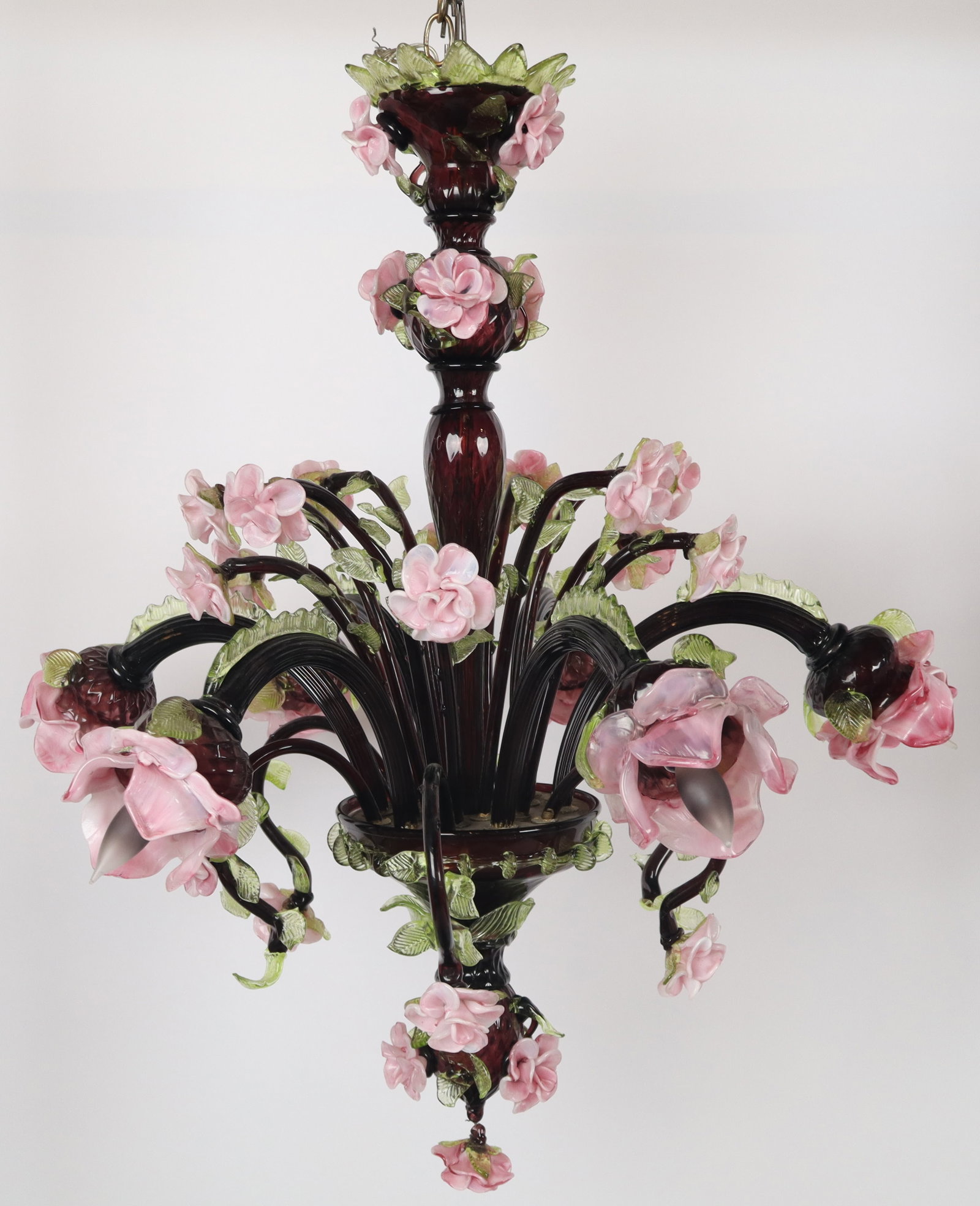 Venetian Murano Glass Chandelier with Roses: Venetian Murano glass chandelier, 20th century, with a purple glass body and rose decoration and six floriform lights. [33" H x 35" Diameter]. Condition is good with some minor losses to glass; wiring
