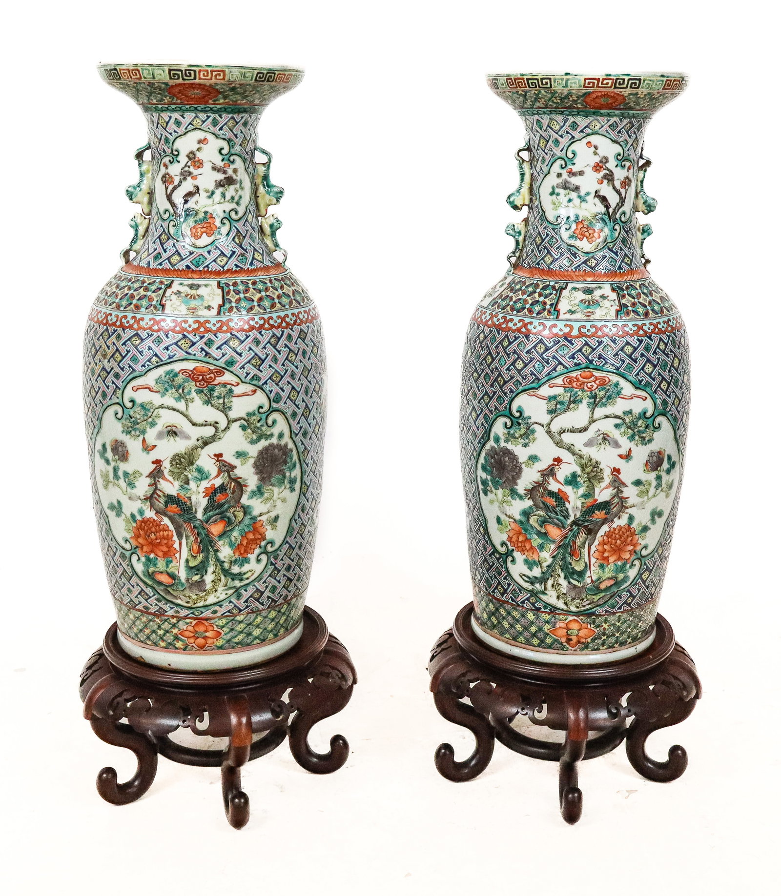 Pair of Chinese Famille Verte Vases: Pair of Chinese famille verte vases, the pair with upper ring lips, above a tapered rounded shape in all over green thatched geometric designs, front and back large reserve panels and intermittent sma