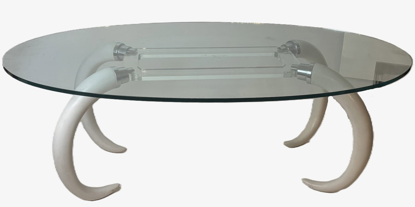 Faux Elephant Tusk and Lucite Table: Faux elephant tusk and lucite table, circa 1970s, likely by Suzzane Dahl & Jerry Barich, with a glass top, unmarked. [28.5" H x 83" W x 47.5" D]. Condition is good with some scuffing to tusks, glass t