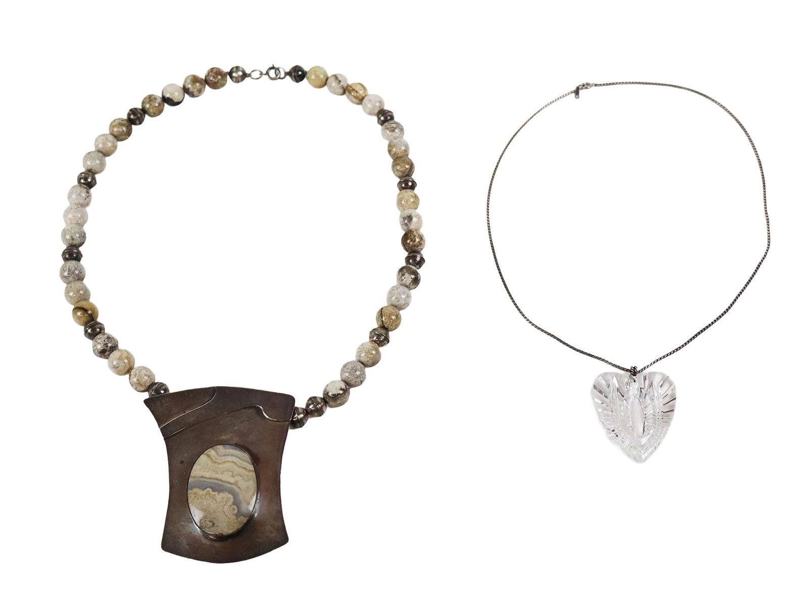 Two Sterling Silver Necklaces: Two sterling silver necklaces, comprising a Waterford heart shaped glass pendant with sterling silver chain, and a PEC agate and sterling silver pendant necklace, marked on pendants. Overall condition