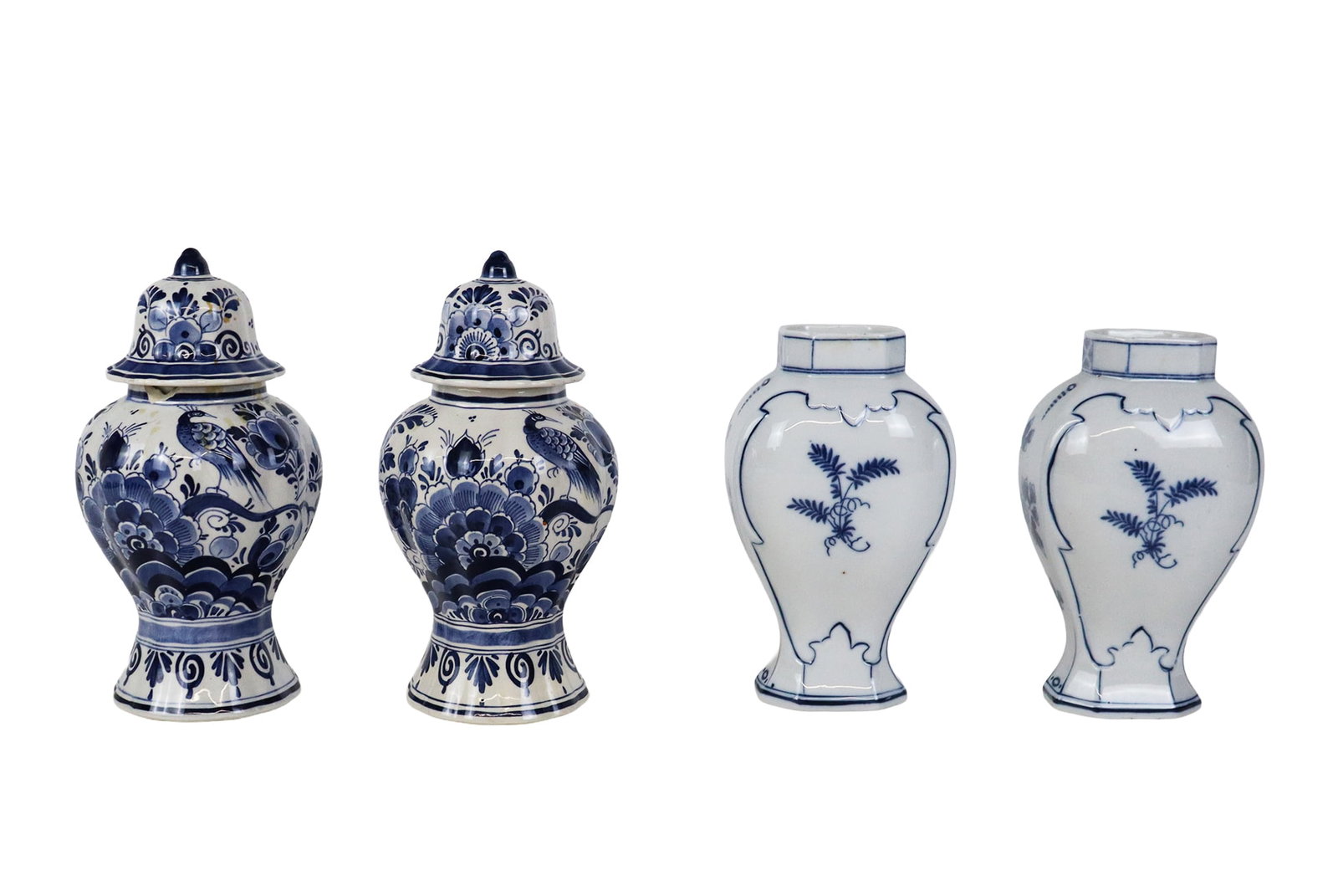 Two Pairs of Delft Articles: Two pairs of Delft porcelain articles, 20th century, comprising a pair of faience decorated covered urns, and a pair of vases, each marked to bases. [Taller pair: 8.5" H x 4.5" Diameter]. Condition