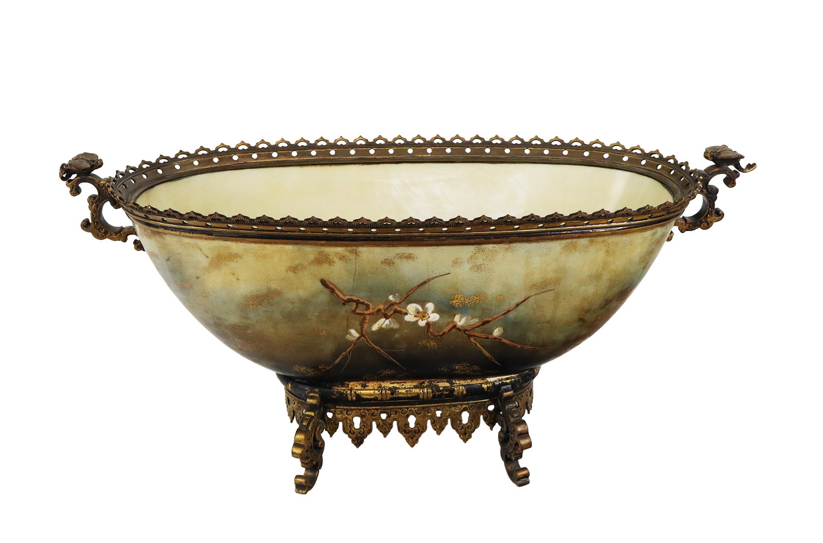 Japanese Export Center Bowl: Japanese export center bowl, 20th century, with hand-applied cherry blossom, moon, and bird decoration, set in gilt metal, unmarked. [9" H x 20" W x 8" D]. Condition is fair with cracks to porcelain