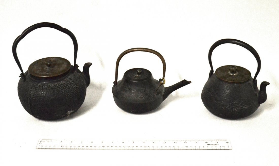 3 Vintage Japanese Cast Iron Teapots: Comprises: 1.) Pot with interlocking geometric design, iron handle, and bronze lid signed on inside. [7 1/8" W x 8 3/8" D x 9 3/4" H]. 2.) Pot with overlapping arc design, iron handle, and bronze lid 