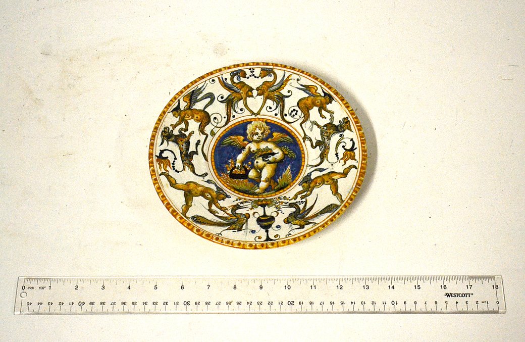 Faience Plate: Italian porcelain plate - cherub medallion figure and animal border. In good condition. [8 1/2" Dia.]