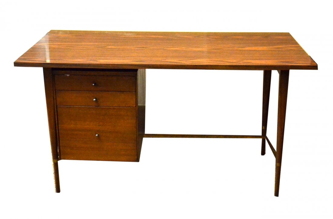 Paul McCobb Desk: Brass and walnut veneer kneehole desk with three drawers. [54" W x 26" D x 29"].