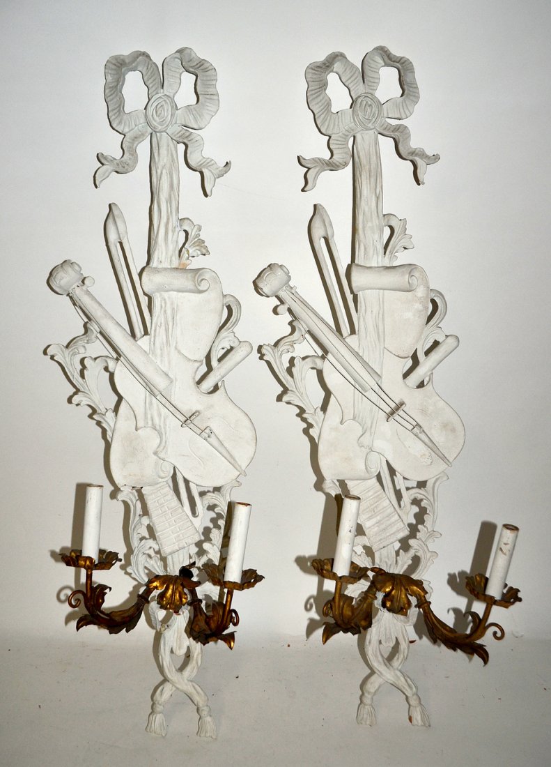 Pair of Hand Carved Louis XV Style Wall Sconces: Painted and decorated musical instrument panels having bow knots with two light sconces protruding.