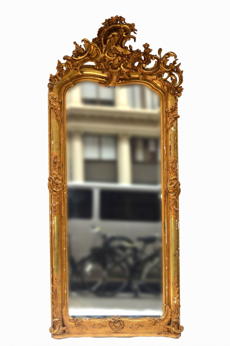 Victorian Pier Mirror: Ornate gilt beveled glass mirror, shell, wood, gesso and wood decor. Some losses, good condition as with age. [92-95" H approx. x 36" W]