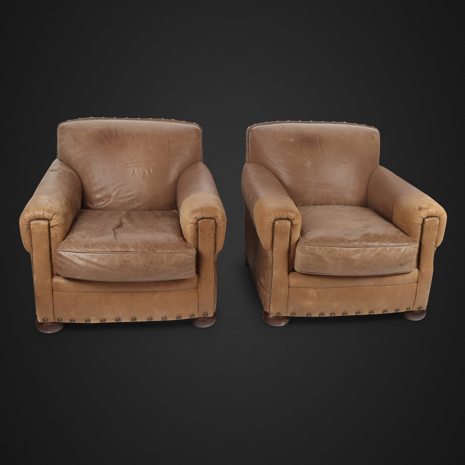 Robb & Stucky Pair of Leather Upholstered Chairs: Pair of Robb & Stucky leather upholstered chairs, 20th century, with two-tone leather detail and nail head decoration, apparently unmarked. [38" H x 36" W x 37" D; seat height: 19"]. Condition to each