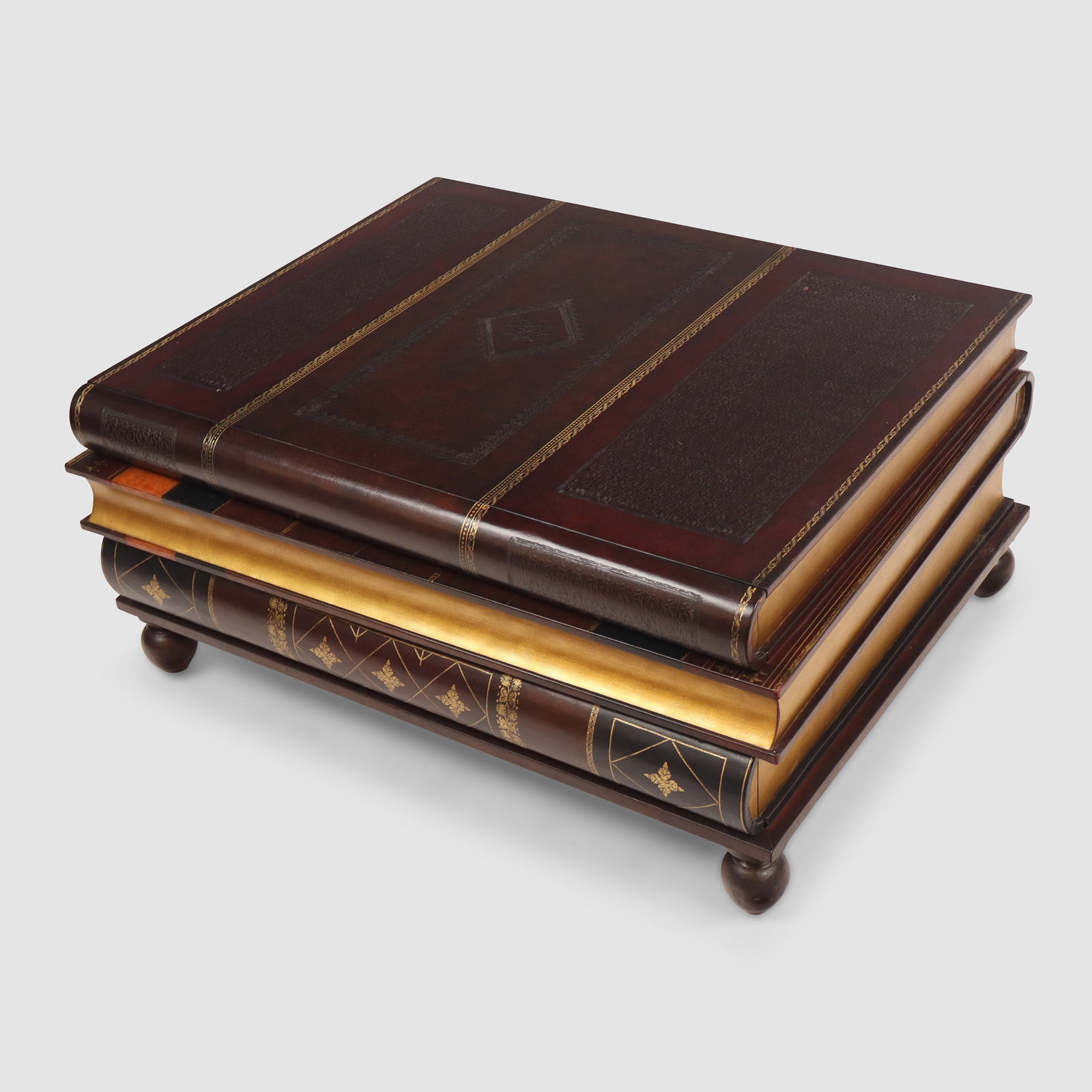 Maitland Smith Leather Book Form Coffee Table: Maitland Smith leather coffee table, 20th/21st century, in the form of a stack of books, with three concealed drawers, marked Maitland Smith to interior upper drawer. [17" H x 35" W x 28" D]. Conditio