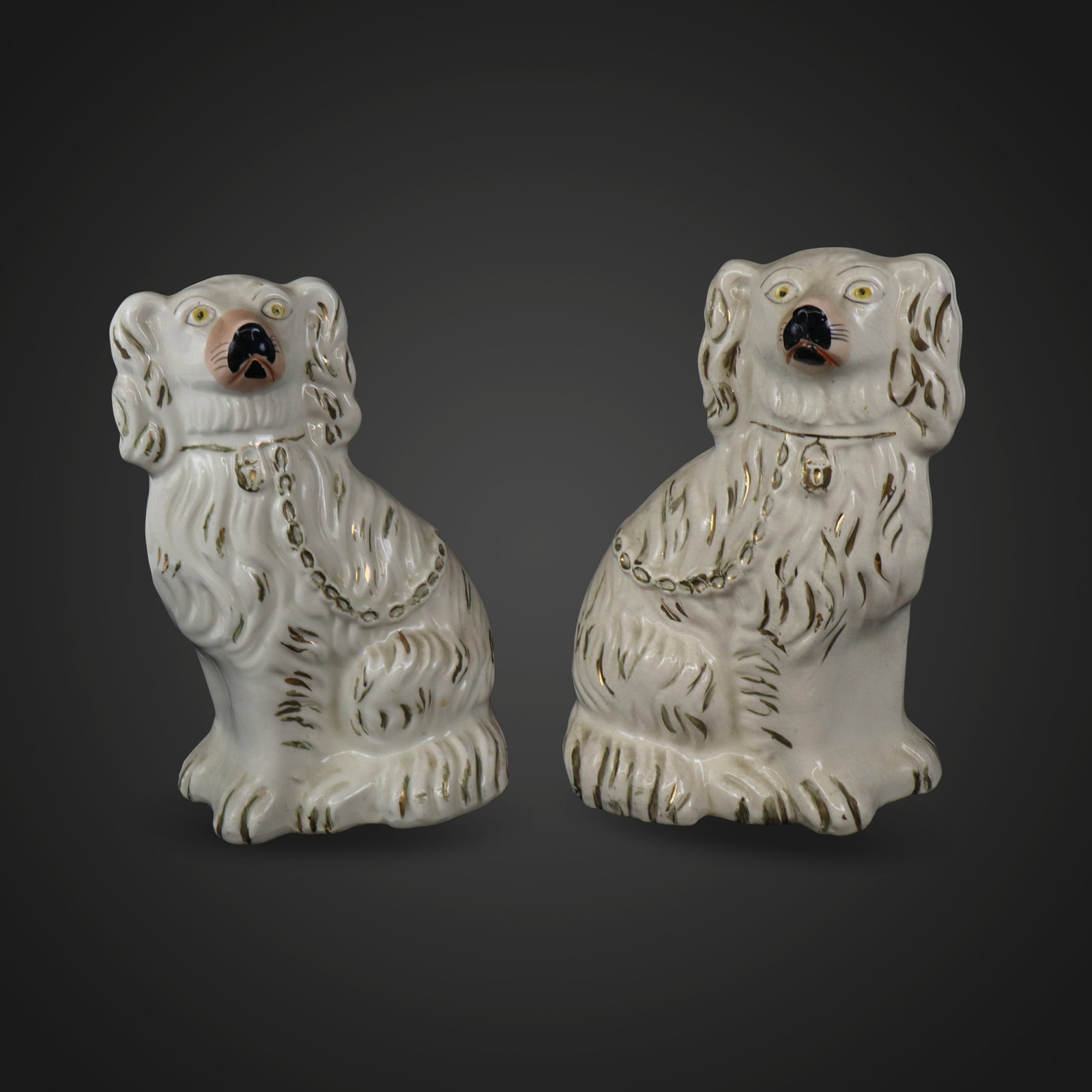Pair of Staffordshire Porcelain Dogs: Pair of Staffordshire porcelain dogs, England, 19th century, with hand-painted and gilt decoration, unmarked at bases. [9.25" H x 6" W x 4.25" D]. Condition is good with surface wear and losses to dec