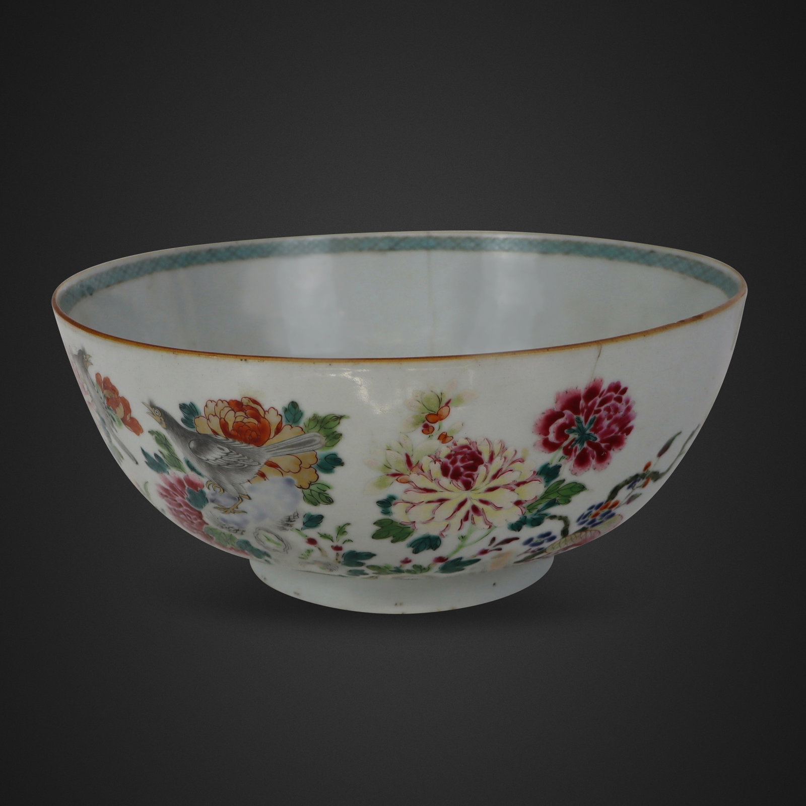 Chinese Famille Rose Center Bowl: Chinese famille rose center bowl, Qing Dynasty, 19th century, with hand-painted floral decoration to outer and decoration to inner rim, unmarked. [4.75" H x 10.15" Diameter]. Condition is good with th