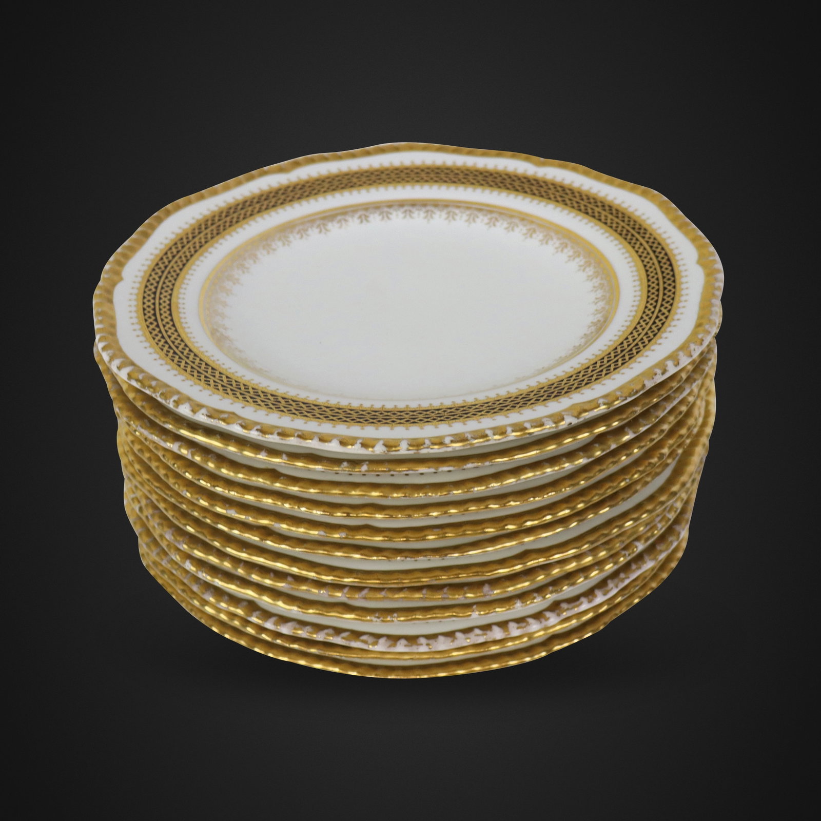 Coalport Porcelain Dinner Plates, 11: Coalport gilt, black and white decorated porcelain dinner plates, English, circa 1891-1919, marks to base. [10.5" Diameter]. Overall condition is good, with loss of gilt to rim.