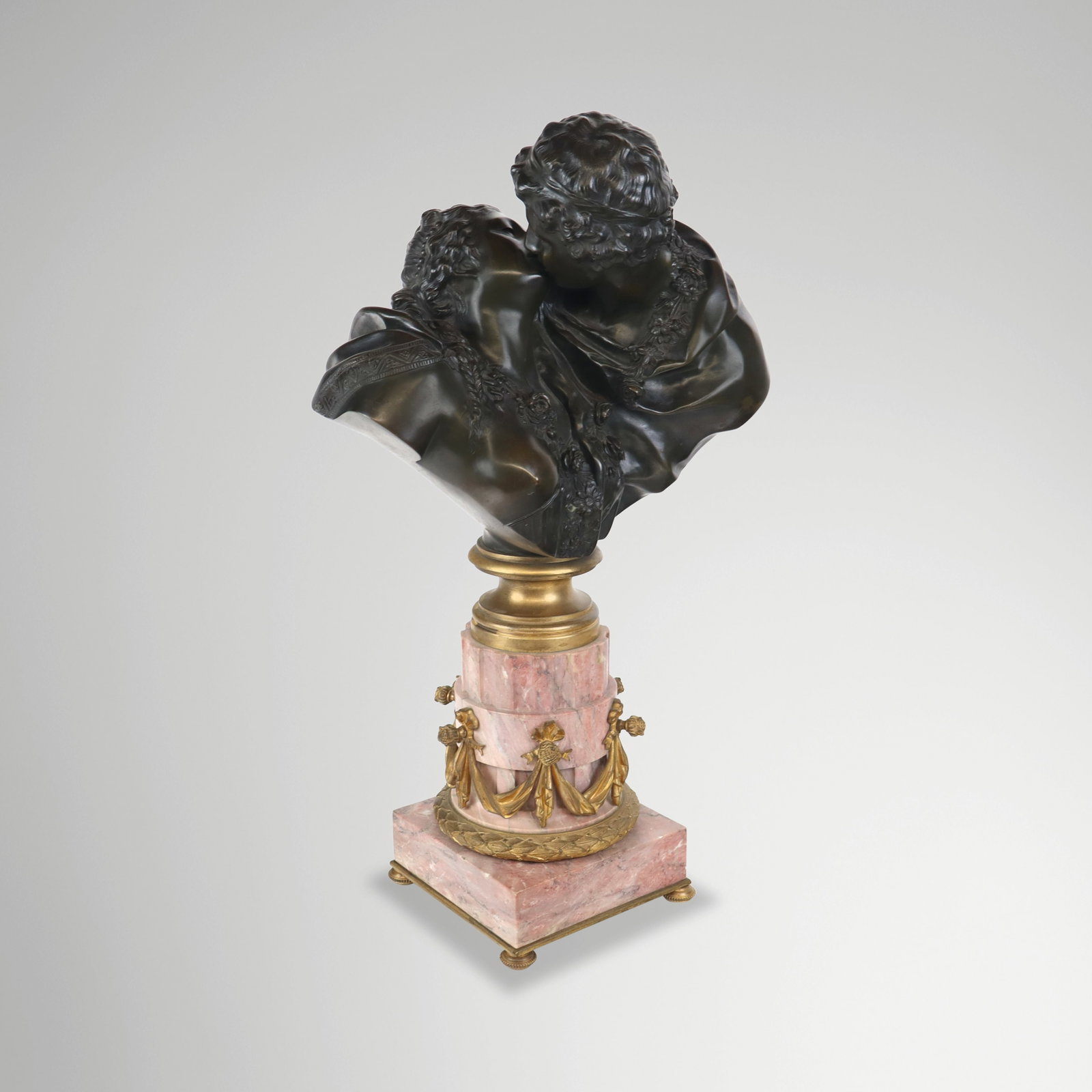 After Jean-Antoine HOUDON "Le Baiser Donne" Bronze: Bronze group after Jean-Antoine Houdon (France, 1741-1828) with bronze to upper and a red marble base mounted in gilt bronze, unsigned. [24" H x 16" W x 8" D]. Condition is good with some minor