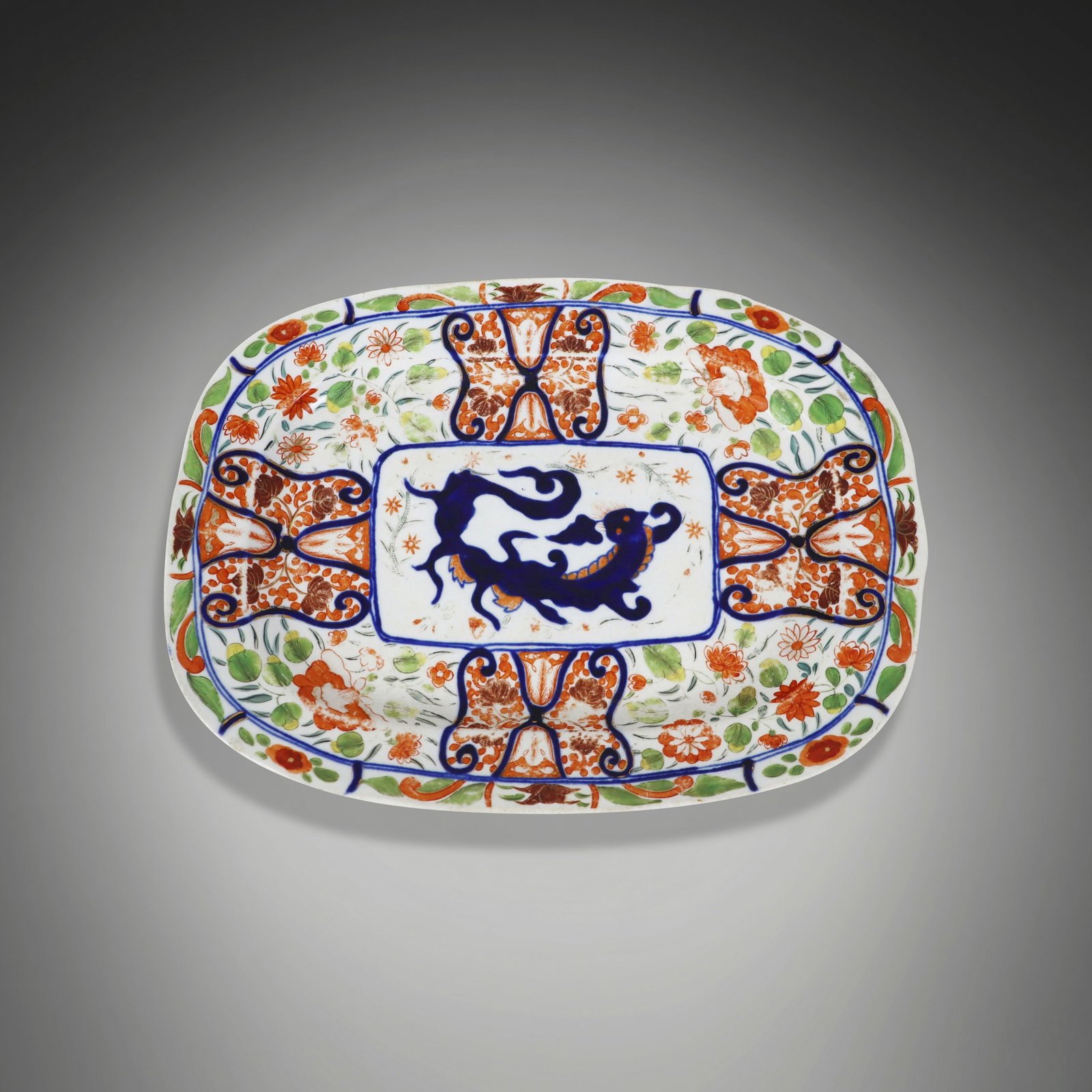 Spode Decorated Platter: Spode decorated platter, 20th century, with hand-applied dragon and floral decoration, marked three to base, otherwise unmarked. [13.5" L x 10" W]. Condition is good to fair with losses to decoration.