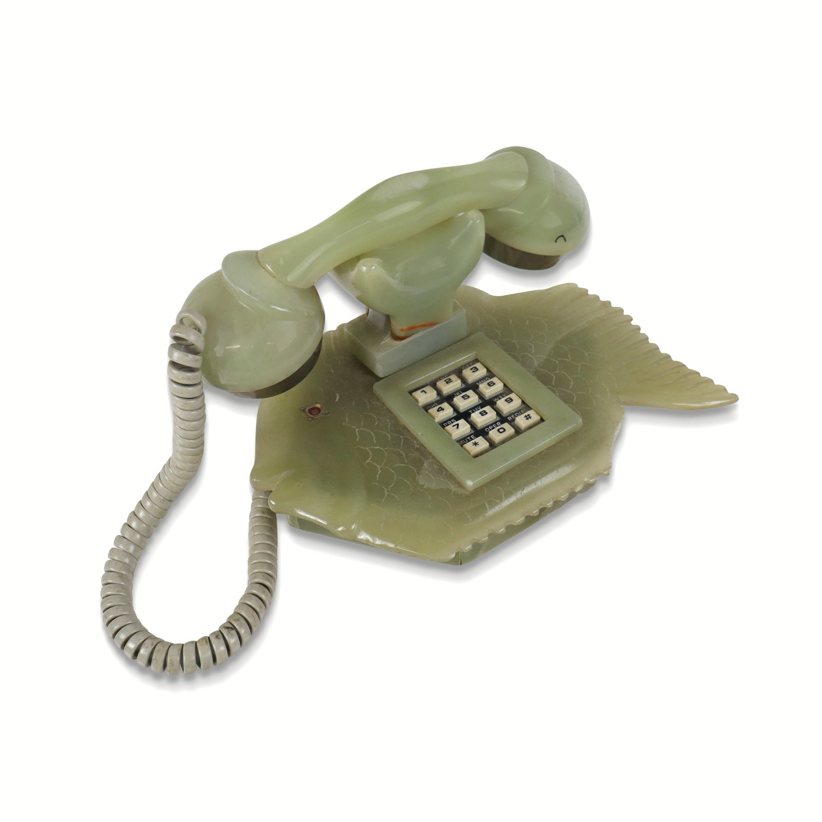 Unusual Carved Green Onyx Fish Phone: Unusual carved green onyx push button fish form phone, unmarked. [5.75" H x 8.25" W x 6" D]. Overall condition is fair, with large chip to upper right, chip to lower right, one rubber foot needs to