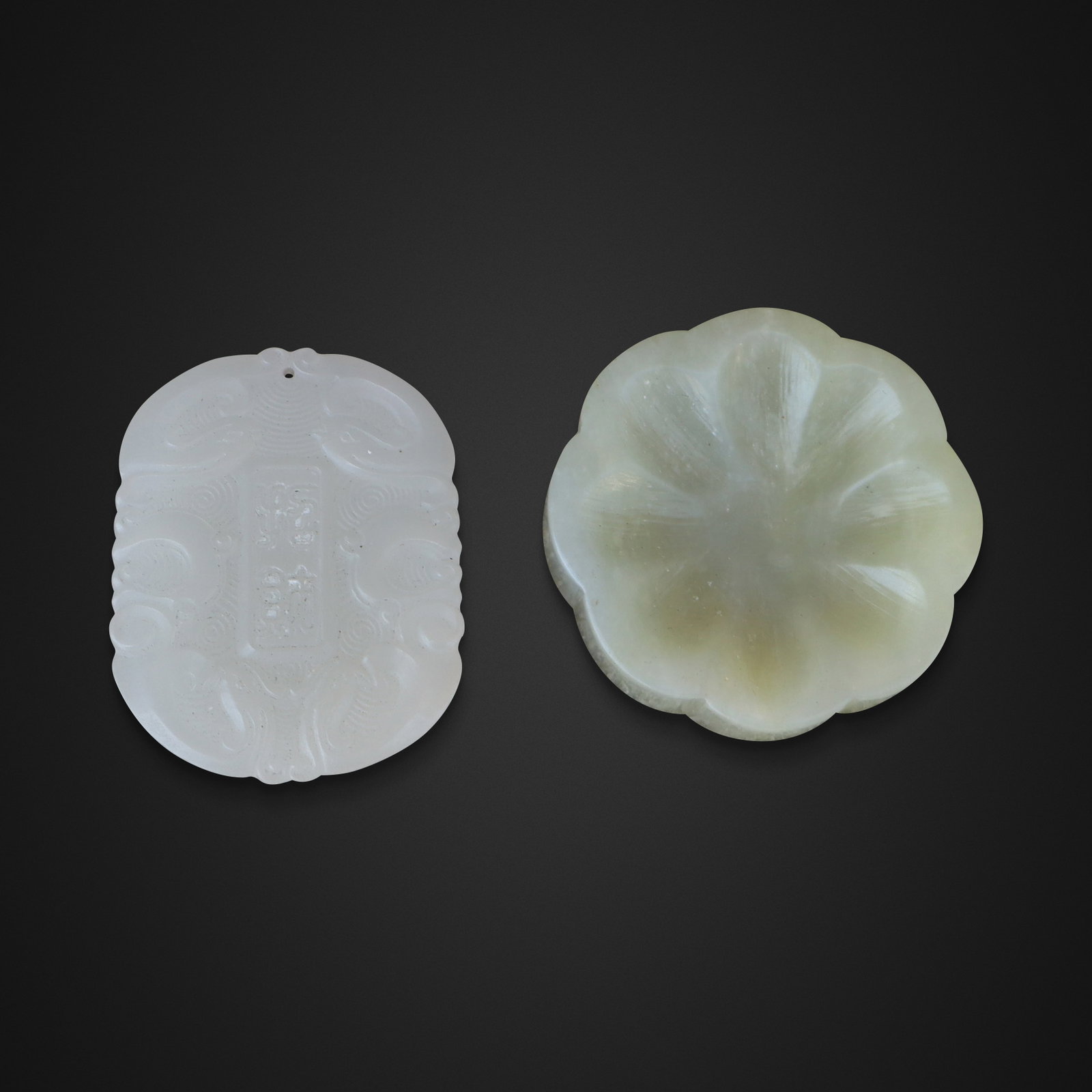 Carved White Jade Pendant and a Lotus Brush Washer: Carved white jade pendant and a green jade brush washer, Chinese, 20th century, the pendant carved with dragon and archaistic decoration. [Pendant: 2.25" H x 1.25" W]. Condition is good.