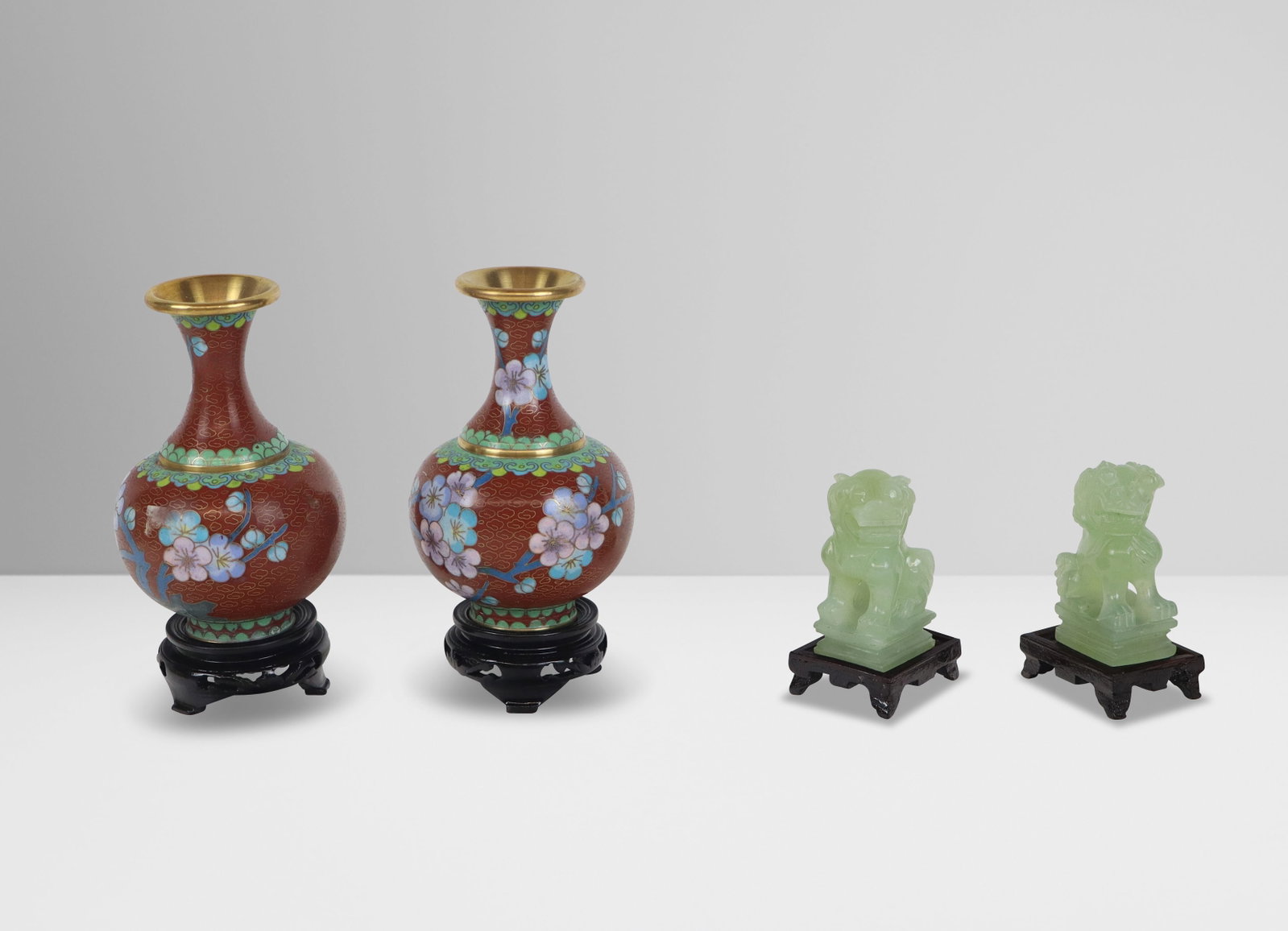 Two Pairs of Chinese Decorative Articles: Two pairs of Chinese decorative articles, 20th century, comprising a pair of faux jade foo dogs on stands, and a pair of diminutive cloisonne vases on stands, each in boxes. [Vases, with stands: 6.5" 