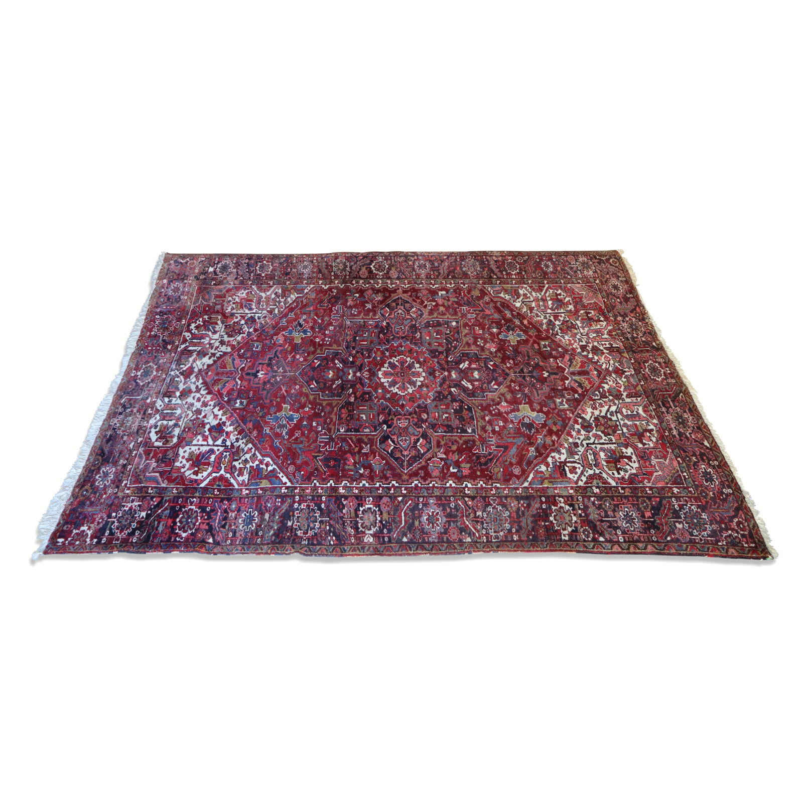Persian Hand-Knotted Wool Heriz Rug: Persian Heriz rug, 20th century, in hand-knotted wool with heavy pile, medallion decoration and ivory accents, with label Made in Iran. [144" L x 106" W]. Condition is good with some areas of minor lo