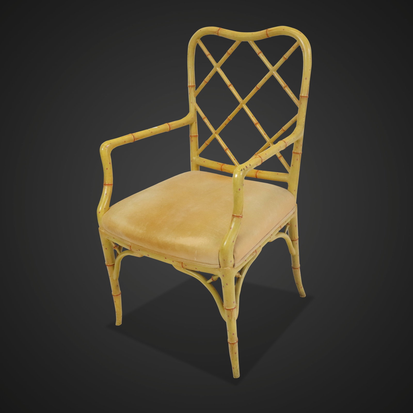 Yellow Painted Faux Bamboo Armchair: Yellow painted bamboo chair, circa 1960s, with orange accents and a yellow velvet upholstered seat. [41" H x 24" W x 21" D; seat height: 19.5"]. Condition is good with some wear and discoloration at s