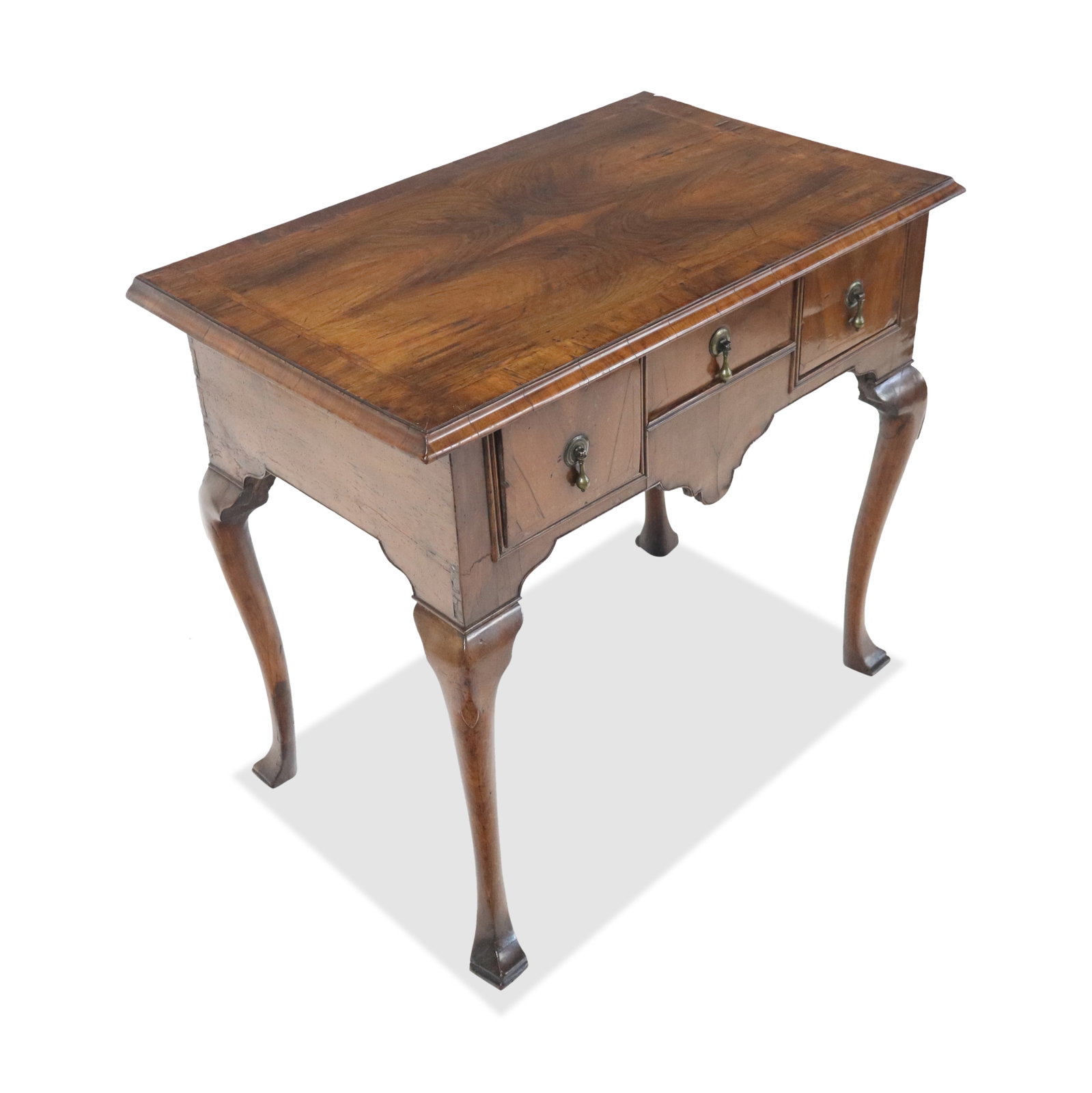 English Mahogany Lowboy: mahogany low boy, 19th century, with three drawers and cabriole legs ending in pad feet. [29" H x 31" W x 19" D]. Condition is good to fair with some minor lifting to veneer and a loss to right side r