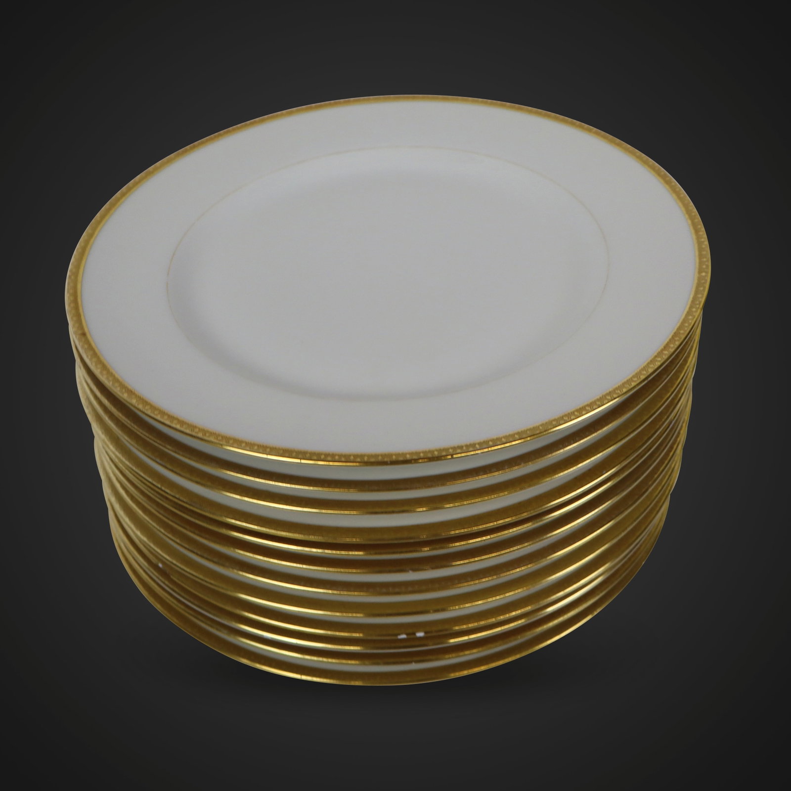 Elite Gilt Decorated Dinner Plates, 12: Elite gilt decorated dinner plates, Limoges, 20th century, marks to reverse. [10.75" Diameter]. Overall condition good/fair, 7 plates in good condition, 5 plates with minor chips to rim.
