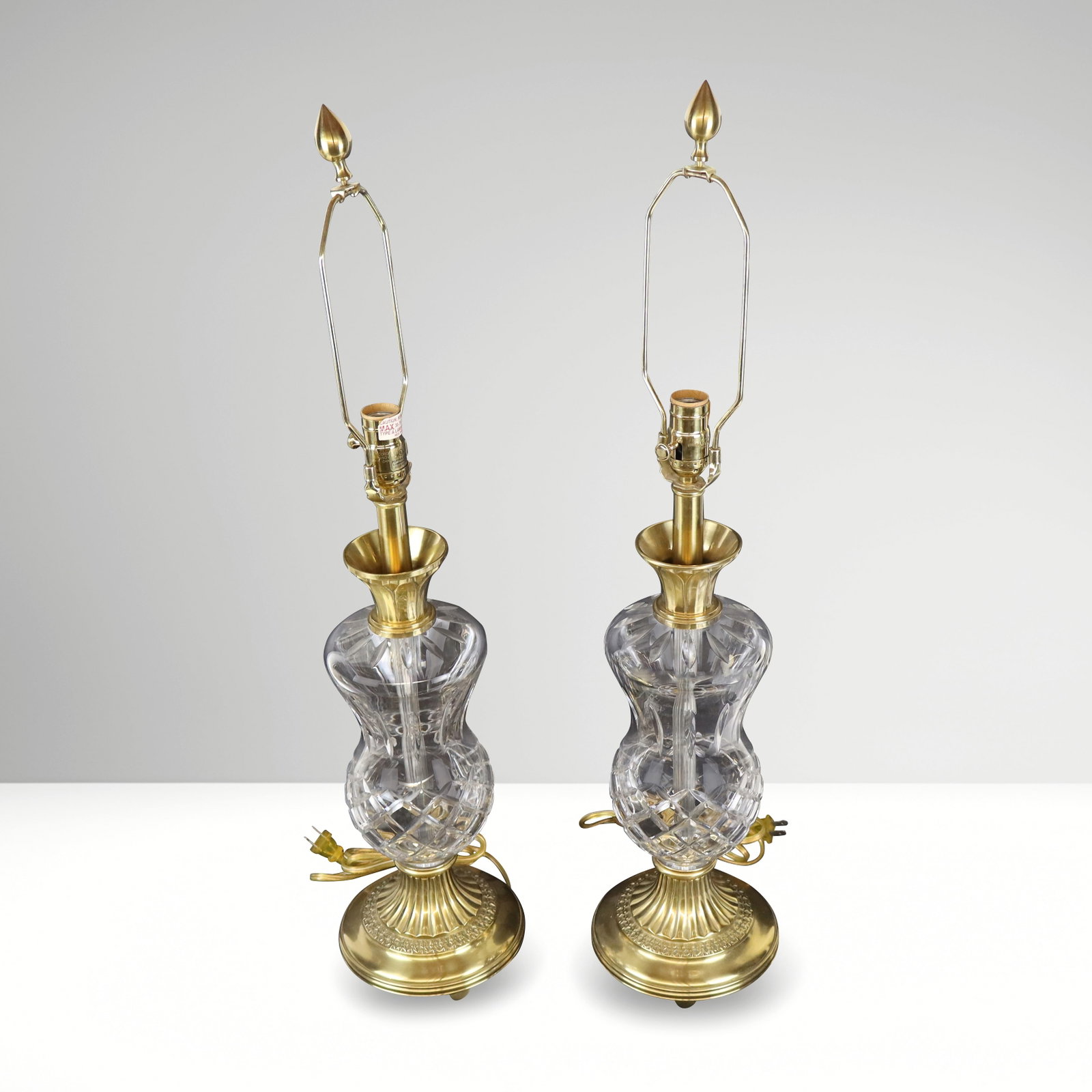 Waterford, Pair of Cut Crystal & Brass Table Lamps: Waterford pair of cut crystal and brass table lamps, bearing paper label. [21.5" H x 7" Diameter]. Overall condition is good, with signs of normal wear, not tested for electricity.