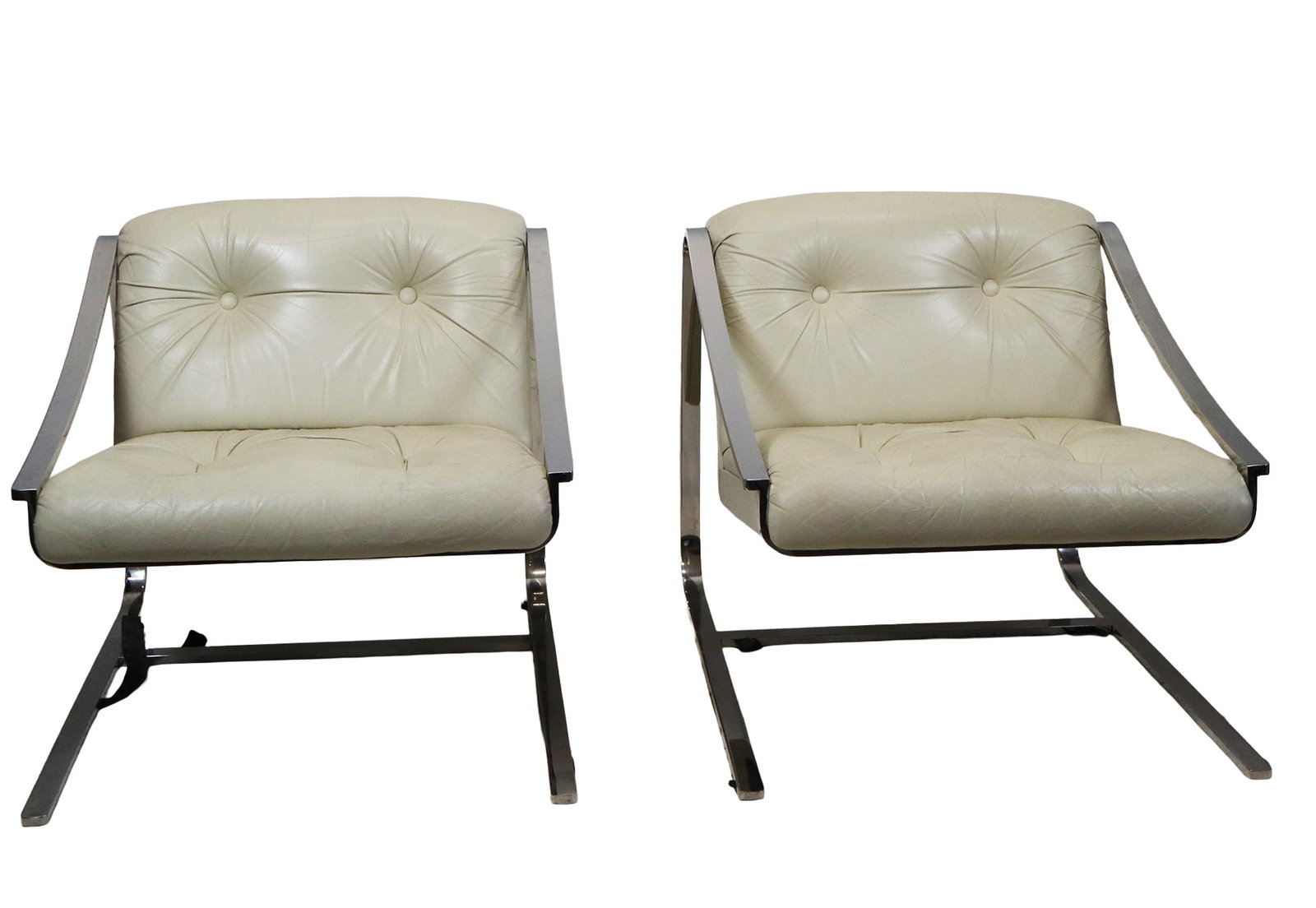 Charles Gibilterra for Brueton Pair "Plaza" Chairs: Pair of "Plaza" cantilevered armchairs by Charles Gibilterra for Brueton, later 20th century, with chrome frames and white leather tufted upholstery, unmarked. [30" H x 30" W x 34" D]. Condition is go