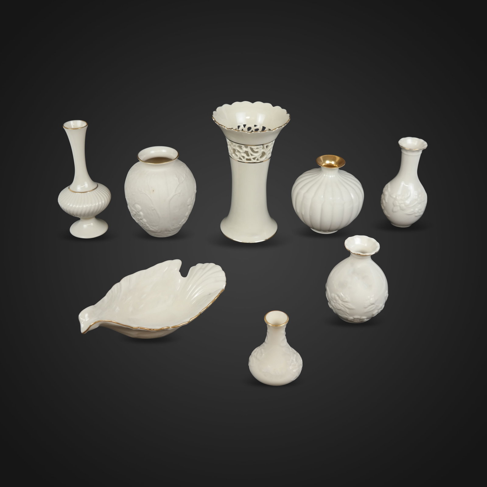 Lenox Cream Colored Porcelain Articles, 8: Lenox collection of assorted cream colored porcelain table articles, comprising a "Dove" dish with 24K gold border [2.5" H x 8" L x 4.75" W], and 7 assorted variously decorated vases [Tallest: 7.5" H 