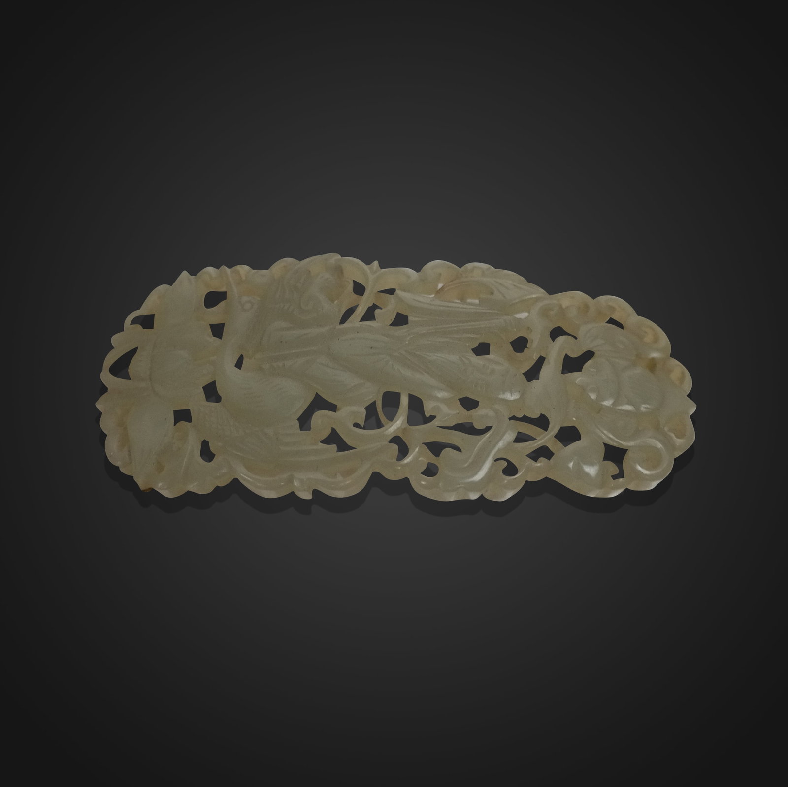 Elaborately Carved Jade Pendant or Clip: Elaborately carved jade pendant, China, 19th century, possibly a hair accessory with a bat to upper, figure to center on a cormorant, over a lotus, and surrounded by foliate carved design. [2.75" H x 