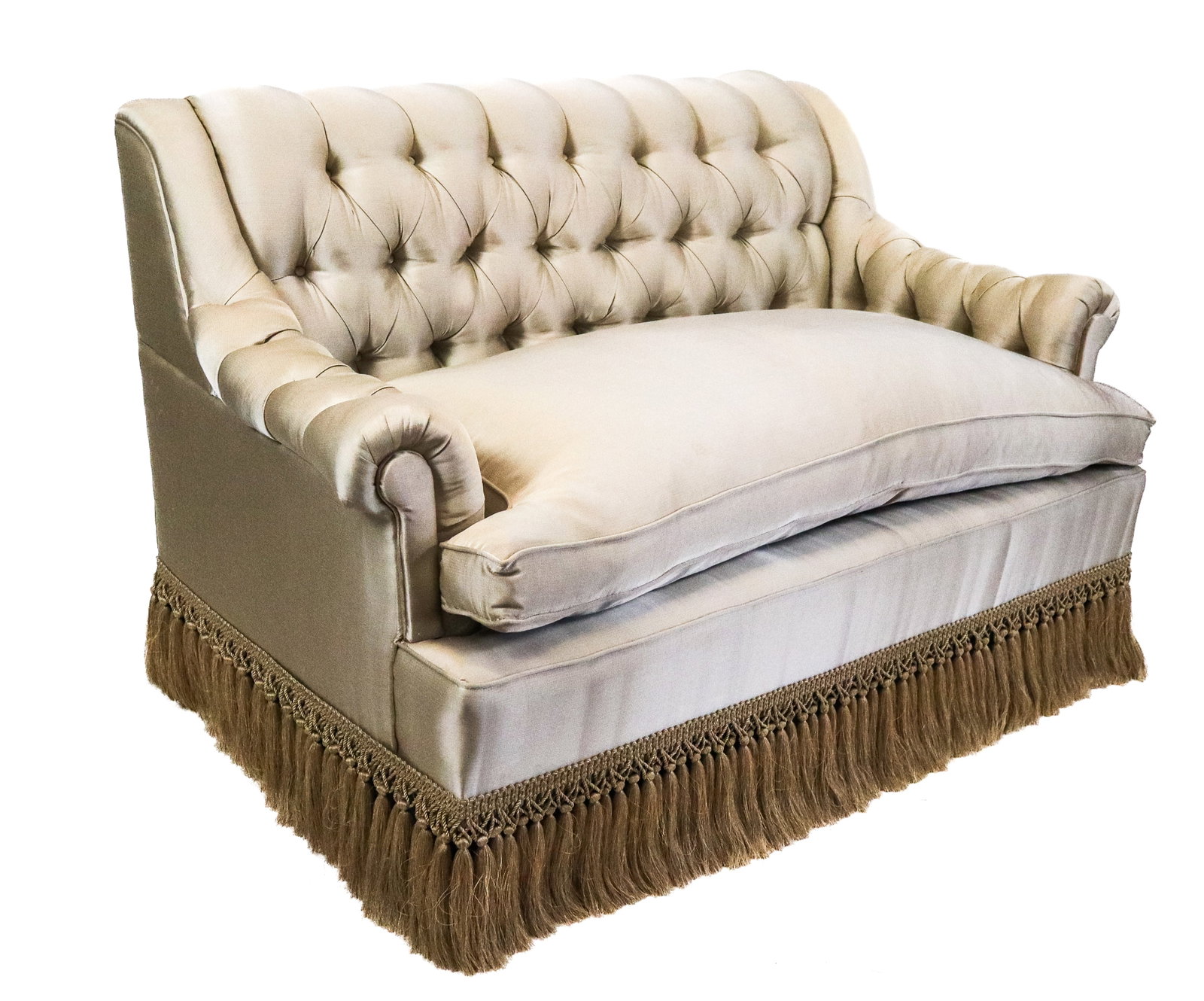 Button Tufted Silk Loveseat: Button tufted tan silk upholstered loveseat with button tufted back, down pad seat cushion, roll arms, and tasseled skirt. [34" H x 56" W x 35" D]. Condition is good with some wear and age-commensurat