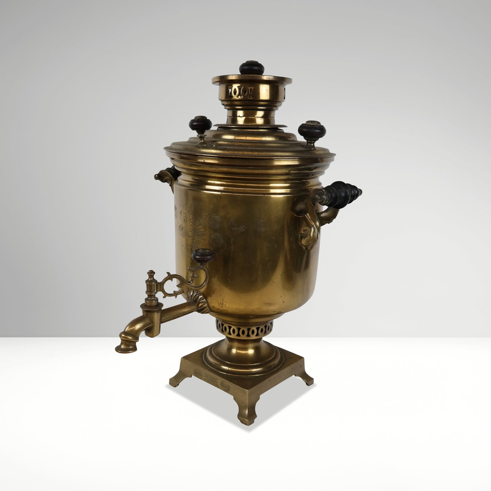 Batashev Antique Brass Samovar: Batashev antique brass engraved samovar, Tula, Russia, of traditional form, the front bearing engraved medals, signed on the foot and body. [19.5" H x 13.5" W x 13" D]. Overall condition is fair, with