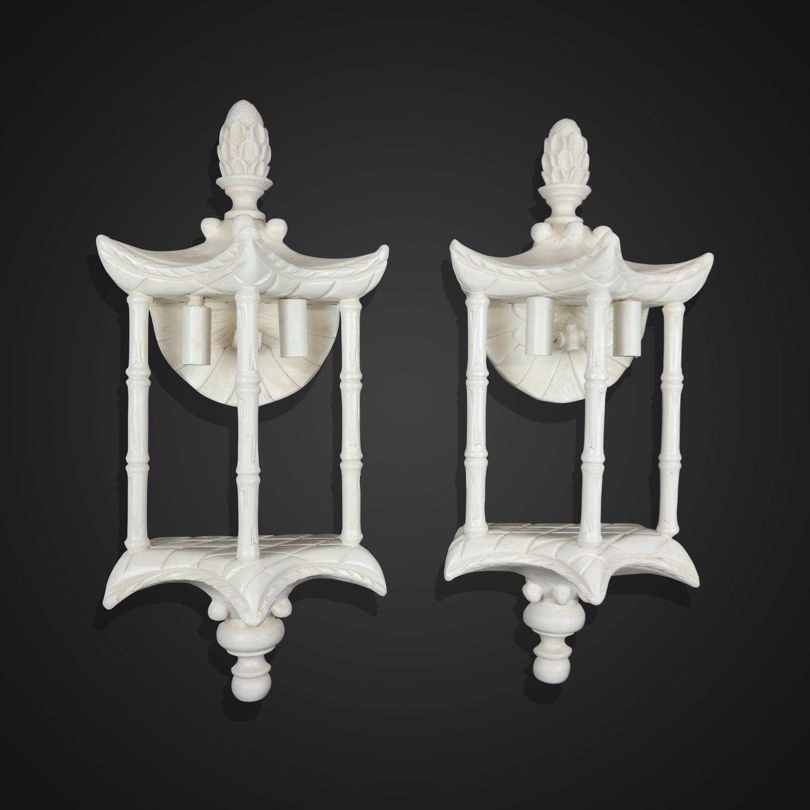 Pair of Pagoda Form Sconces: Pair of carved pagoda form sconces, 20th century, with two lights, and a white painted finish. [21" H x 9" W x 6.5" D]. Condition to each is good; wiring untested.